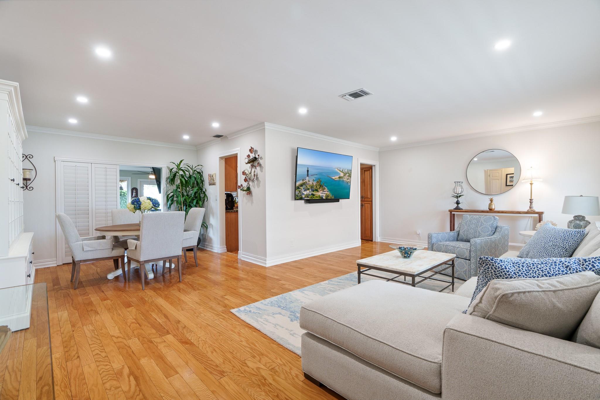 Living room view to dining room with kitchen adjacent