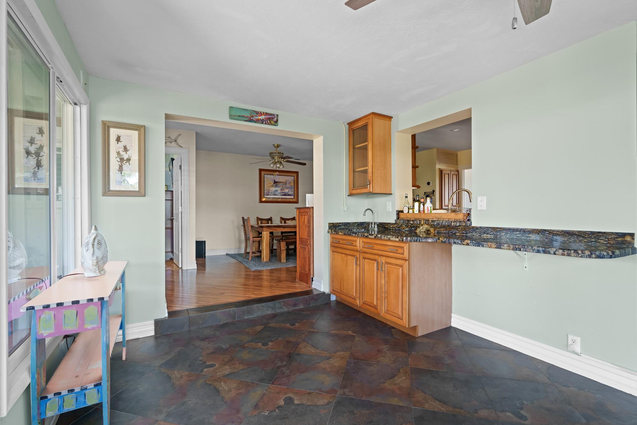 Florida room with wet bar and pass through to kitchen and into both dining areas