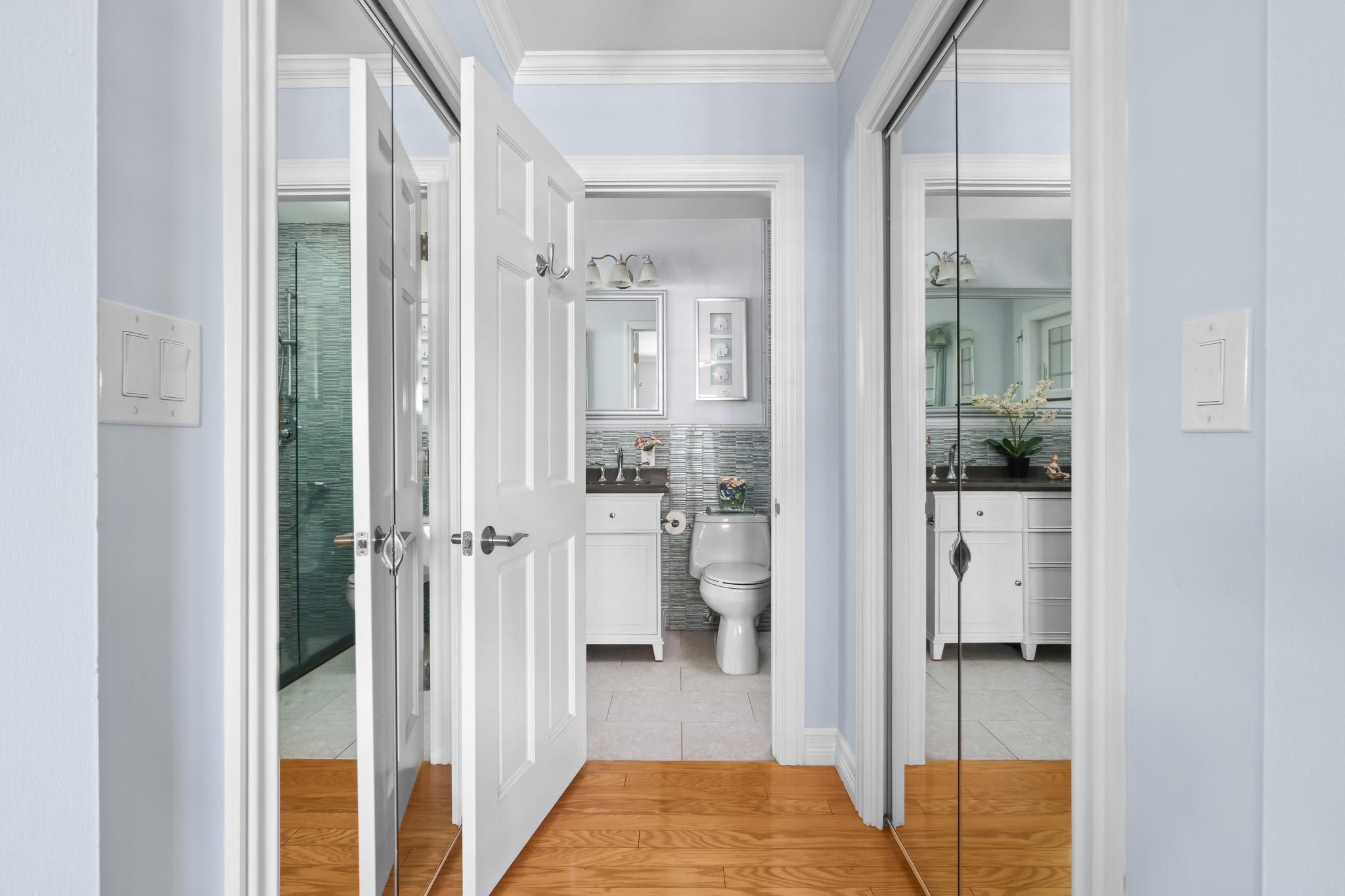 Double walk in closets on either side of primary bedroom into en suite bath