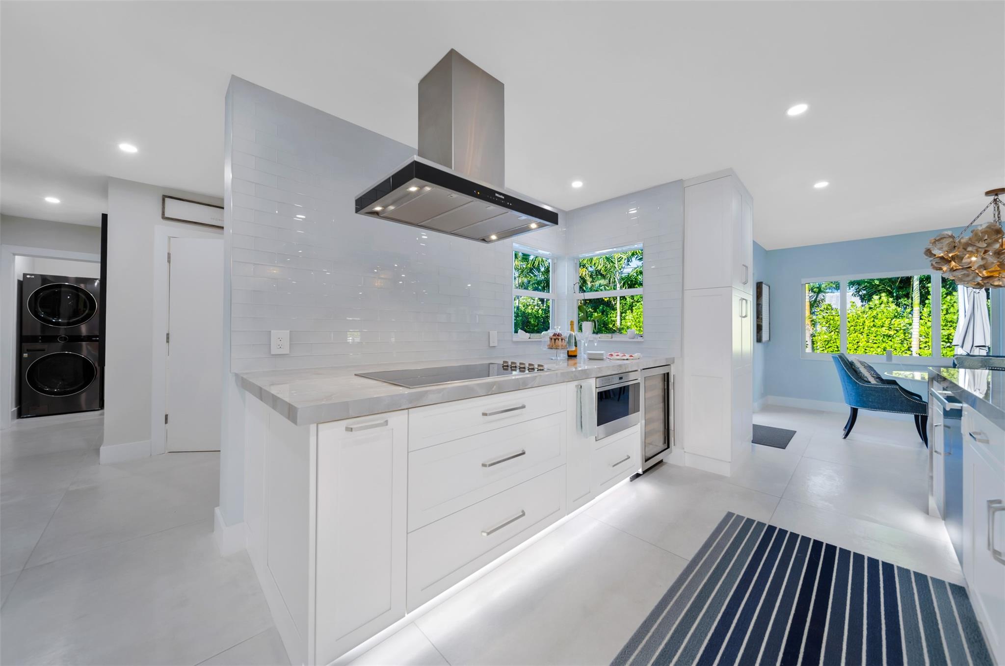 Extra deep quarts counter top, MILE cooktop & hood, Wolfe drawer micro wave and Wolfe wine cooler.