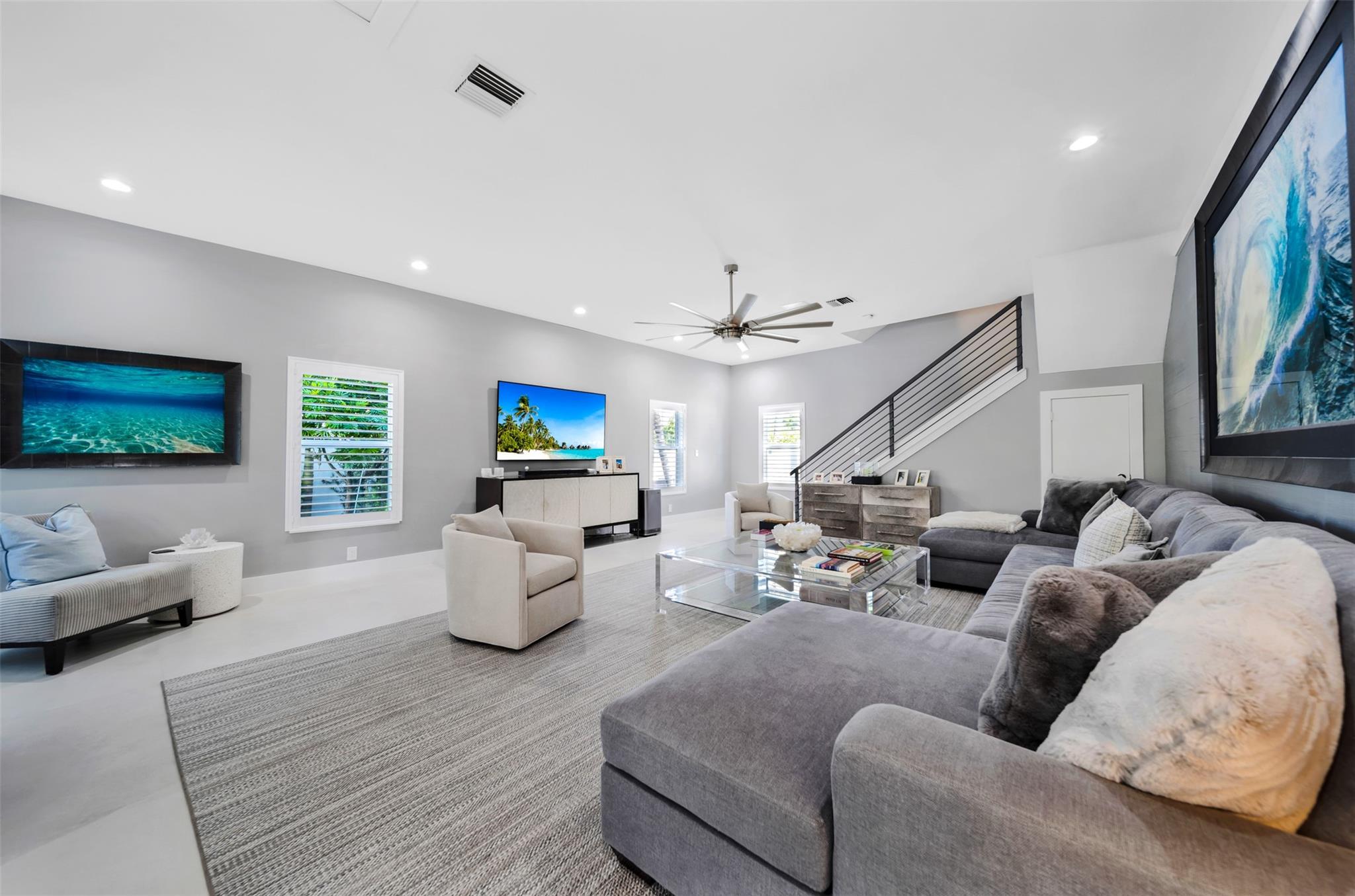 Spacious Living room with stair case to the primary master bedroom & bathroom on the second floor.