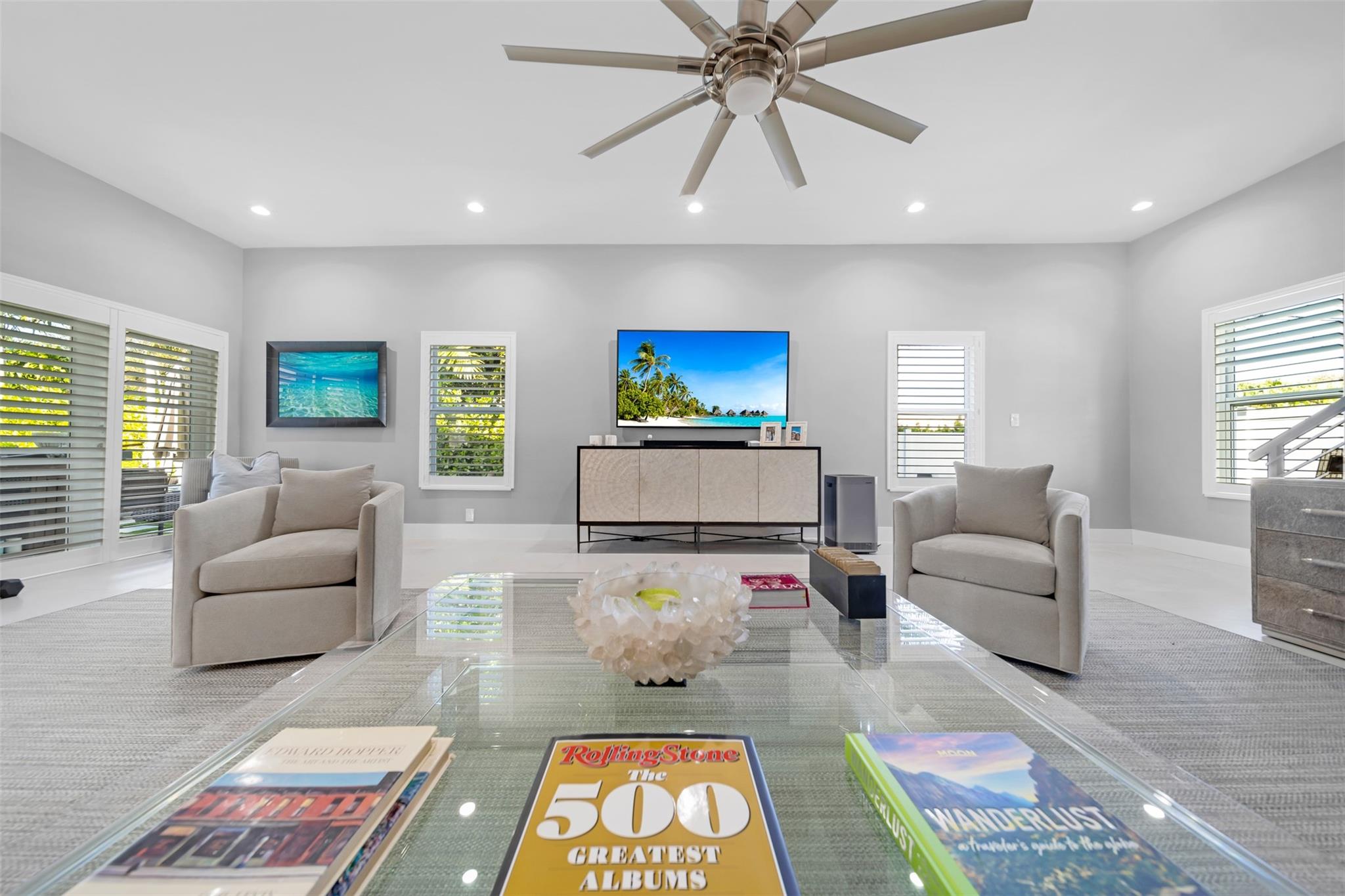 Living room view from the sectional towards entrainment center and windows.