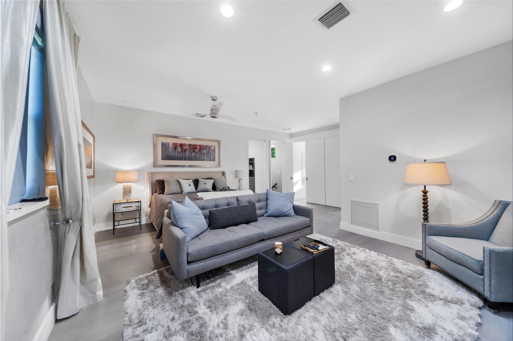 Primary bedroom suite on the second floor, high ceilings, electronic blackout shades