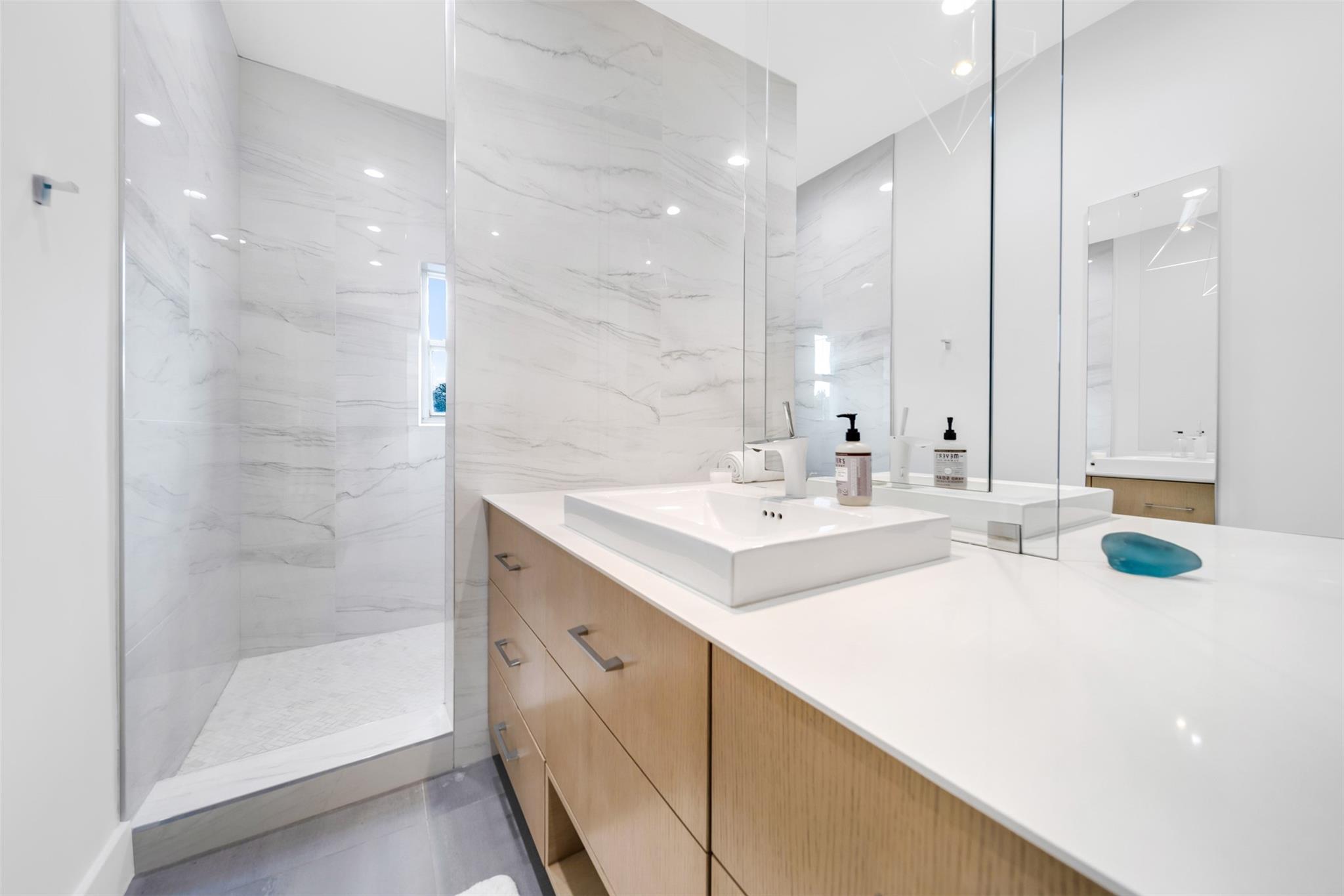 Primary en suite bathroom with double mirror & double sink and walk in shower