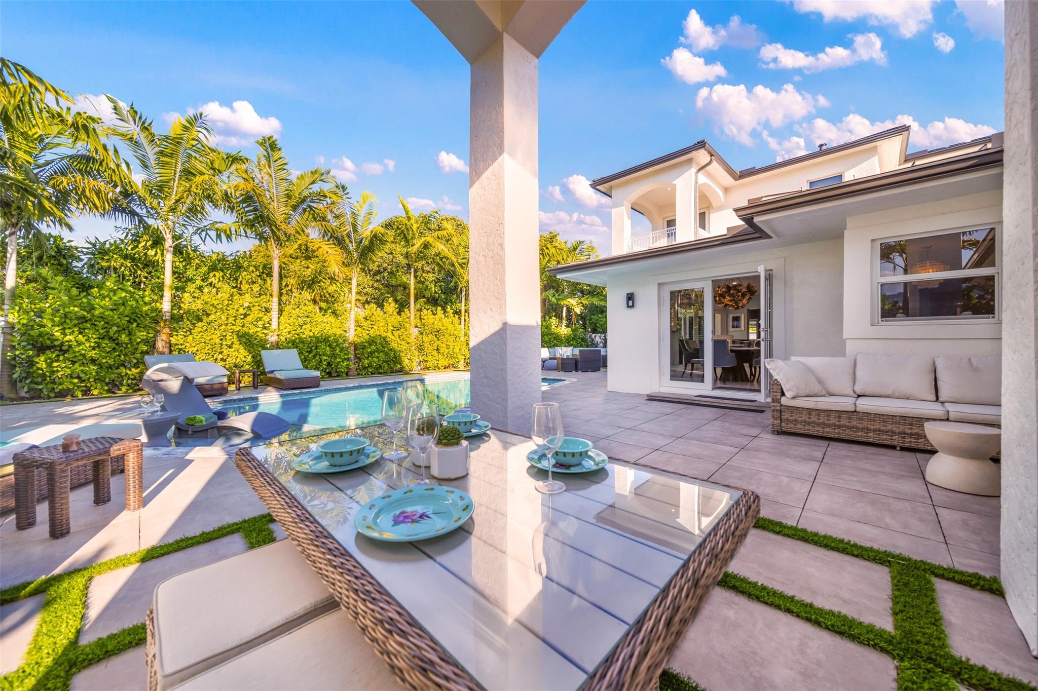 Covered outdoor dining area with sitting area to the side.