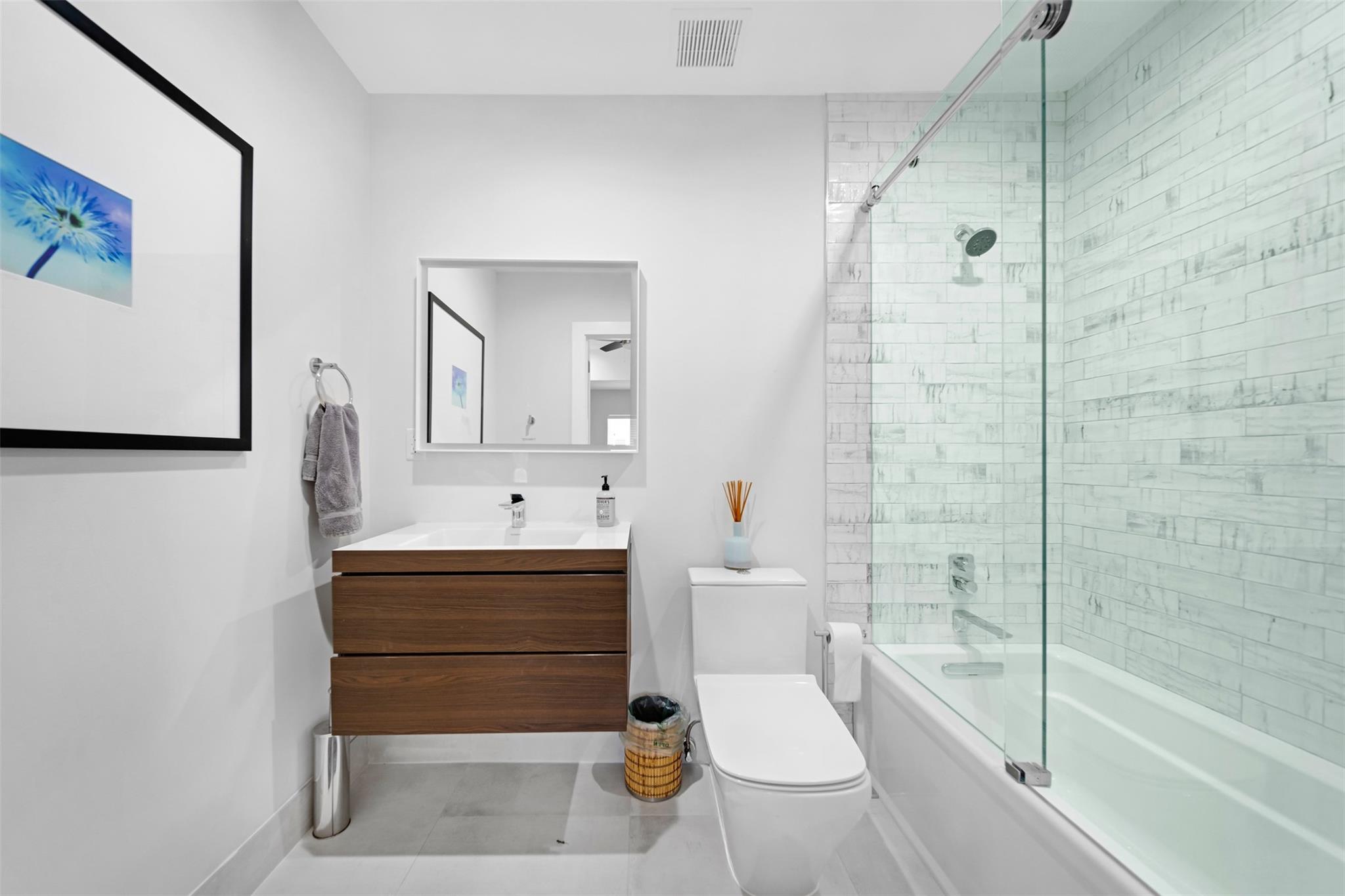 En suite bathroom to 2nd bedroom with shower tub combination.