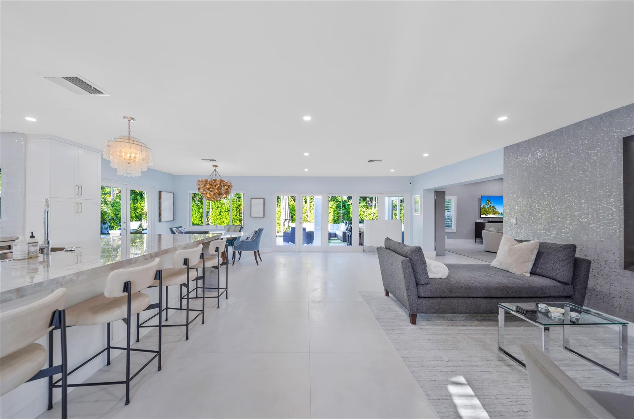 View from the entrance, Kitchen, laundry room, pool cabana bathroom and garage to your left. Front sitting area and two guest bedrooms and bathroom to your right. Also to your far right the formal spacious living room.