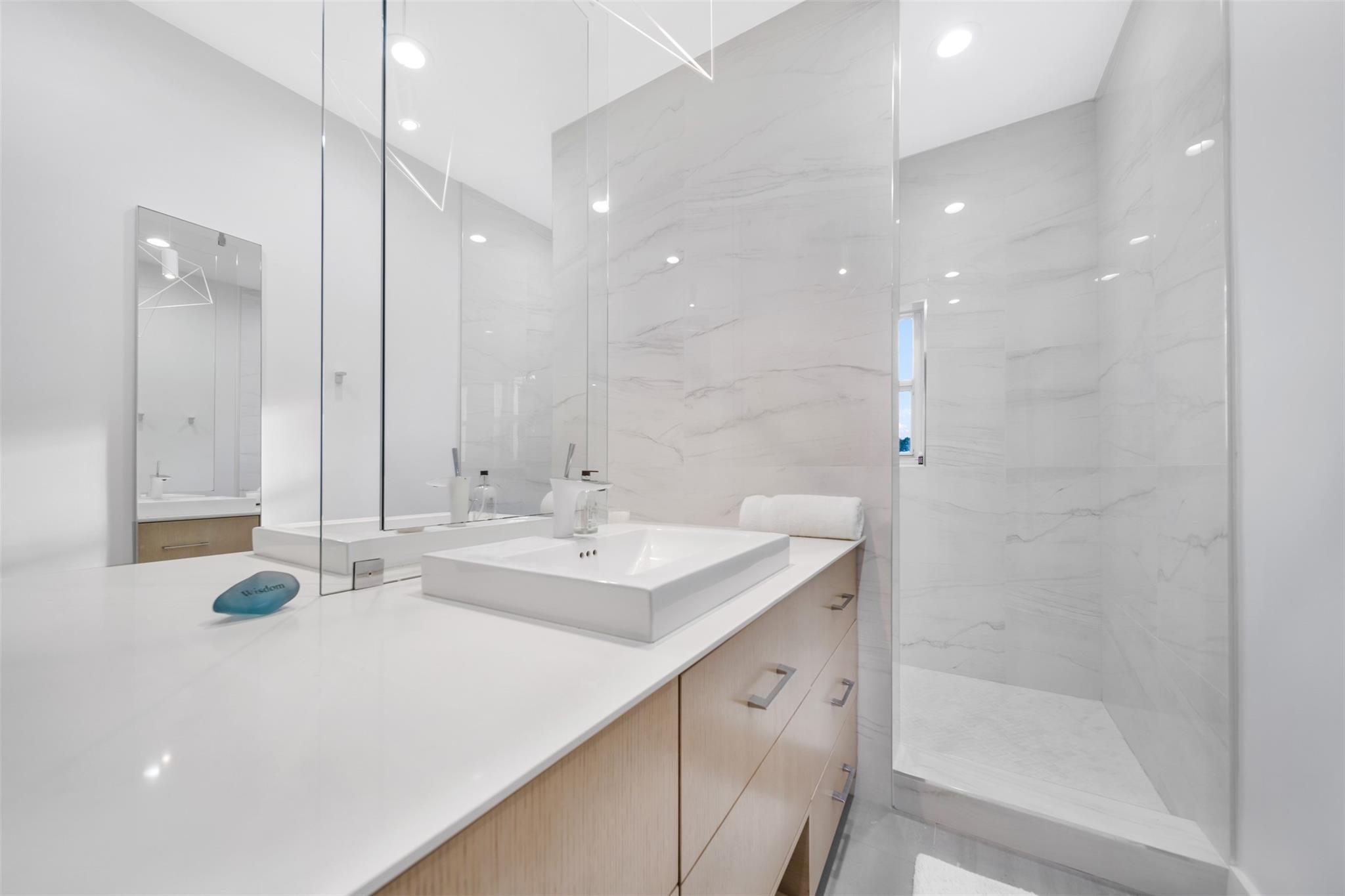 Plenty of space for two, with double mirror, double sink and double entry shower in master.