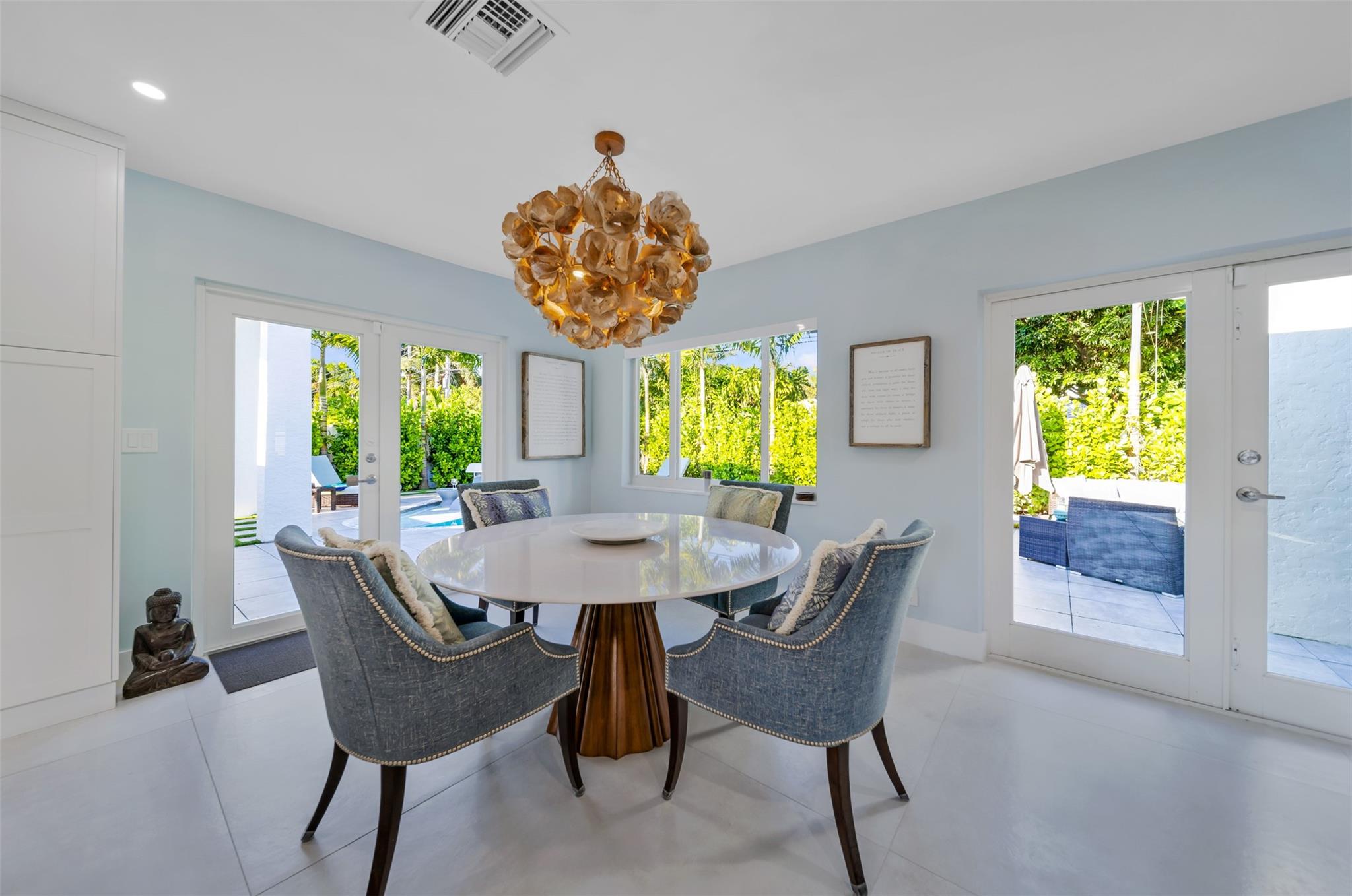 Formal dinning room table wrapped by the views to your serene backyard & pool area.