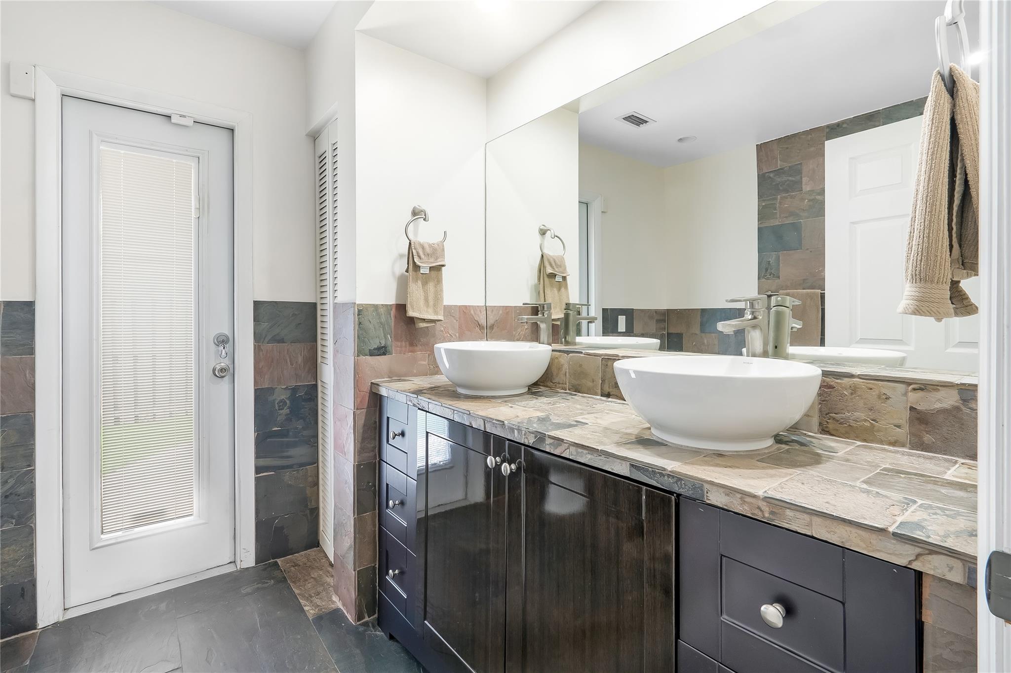 Door to pool and side yard in 3rd full bathroom