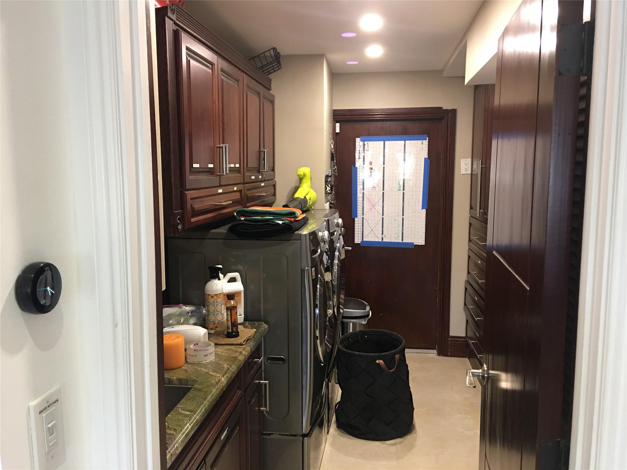 LAUNDRY ROOM- SINK, GRANITE TOP CABINETS, BEST LG WASHER & DRYER & LOADS OF STORAGE  + DOOR TO GARAGE