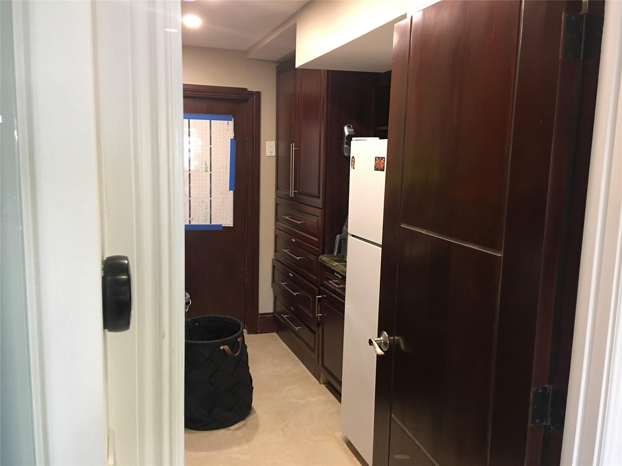 LAUNDRY ROOM- LOADS OF STORAGE IN CUSTOM CABINETS & REFRIGERATOR