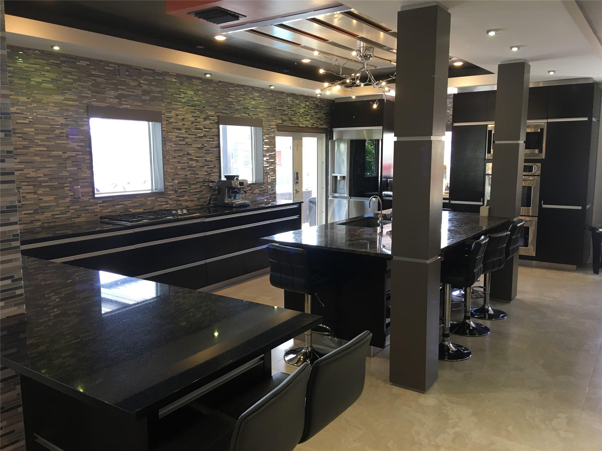SPACIOUS KITCHEN WITH GRANITE TOP CABINETS & BAR STOOLS