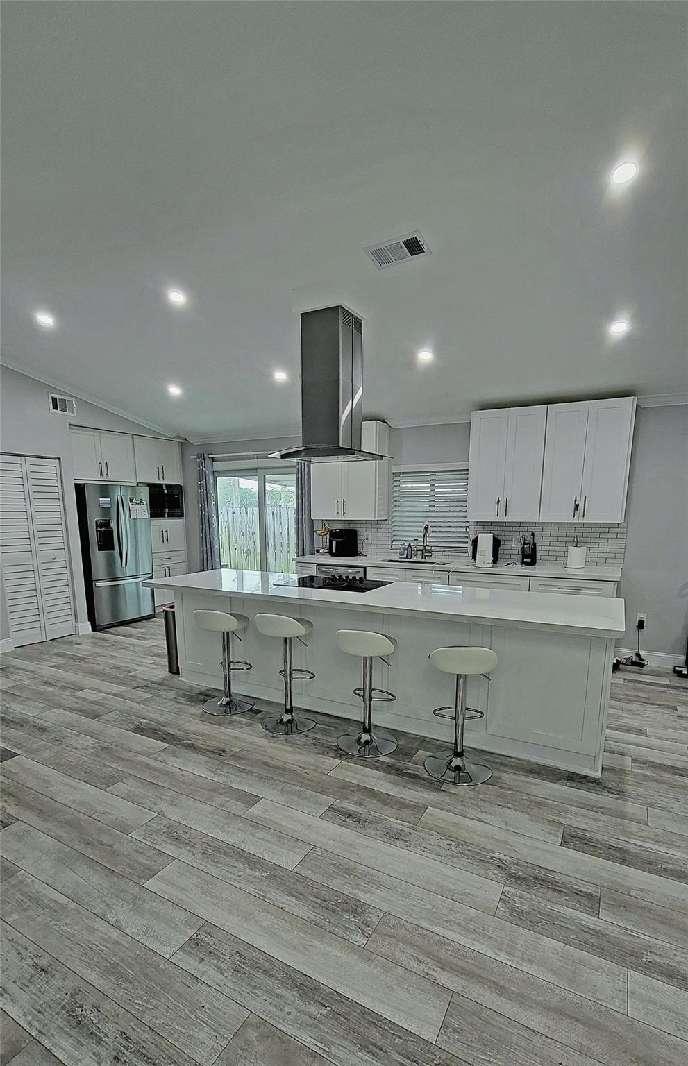 Kitchen Island with cooktop and eating area