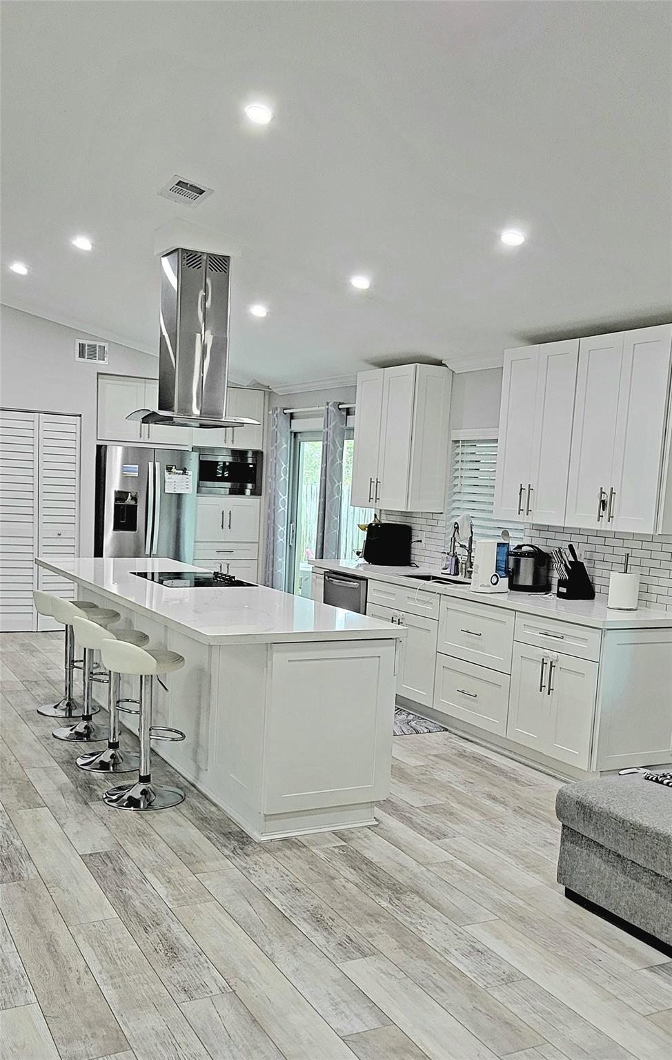 A white kitchen and pleny of lighting