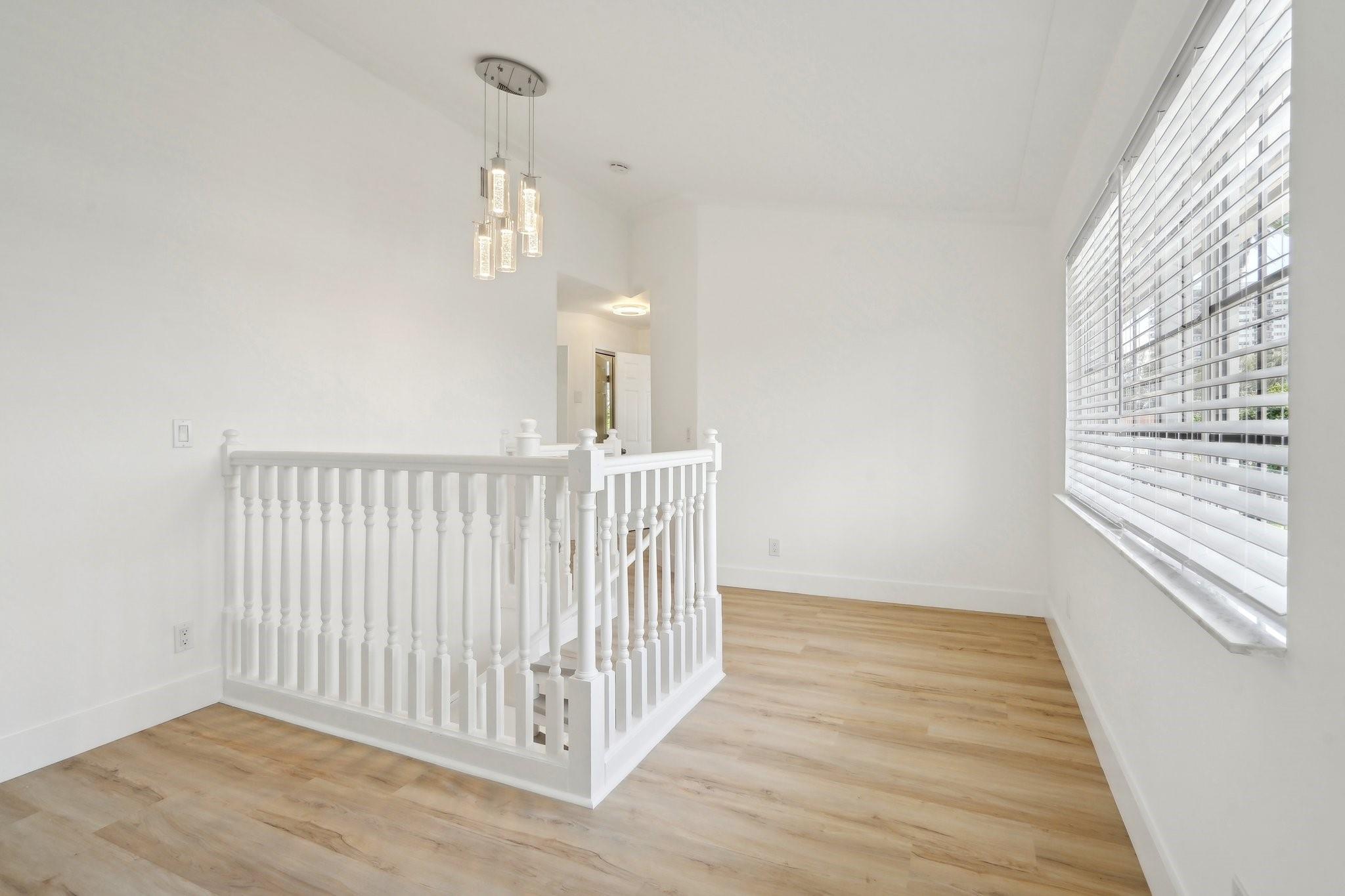 large landing with sitting area/work area/etc. light and bright