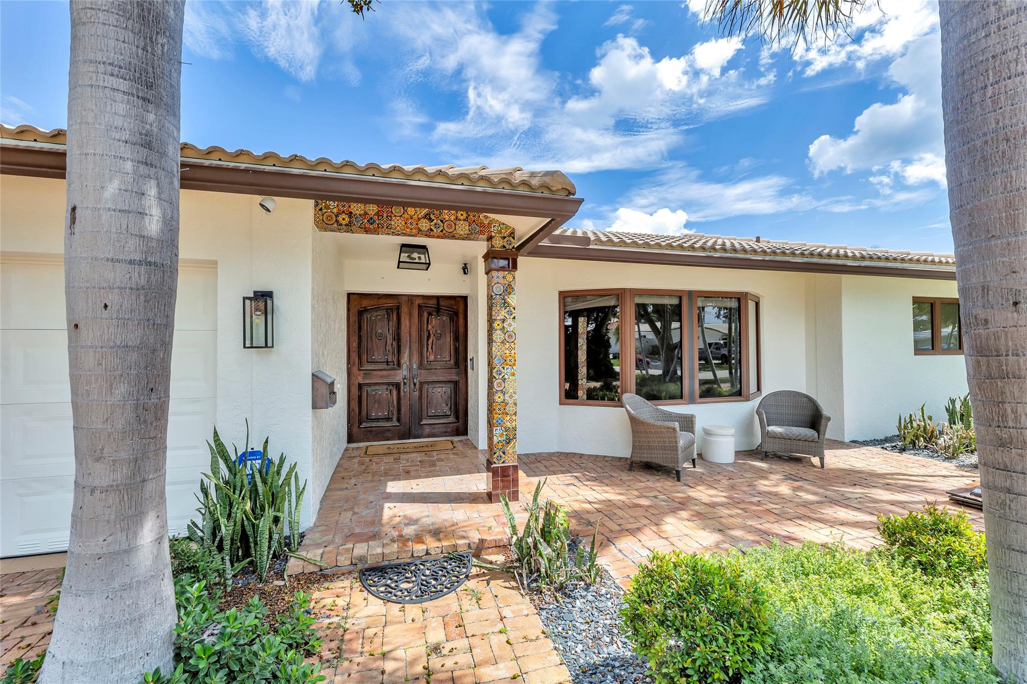 Large front pavered patio provides a great space to enjoy outside and neighboring