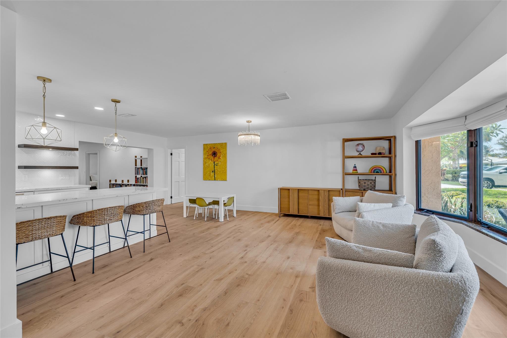 Living Room features a bay window that provides an abundance of natural light and offers a large breakfast bar shared with living room and kitchen