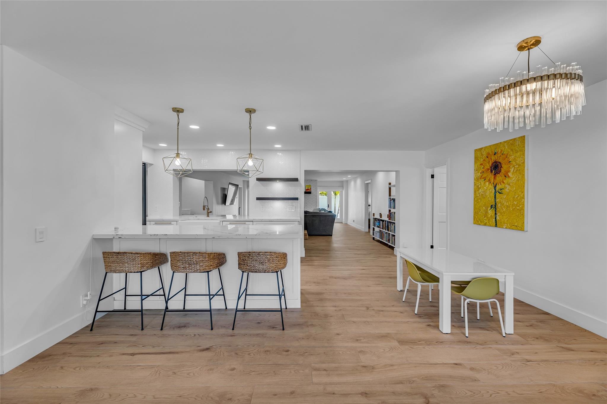 Kitchen features large breakfast bar with high-hat and custom lighting
