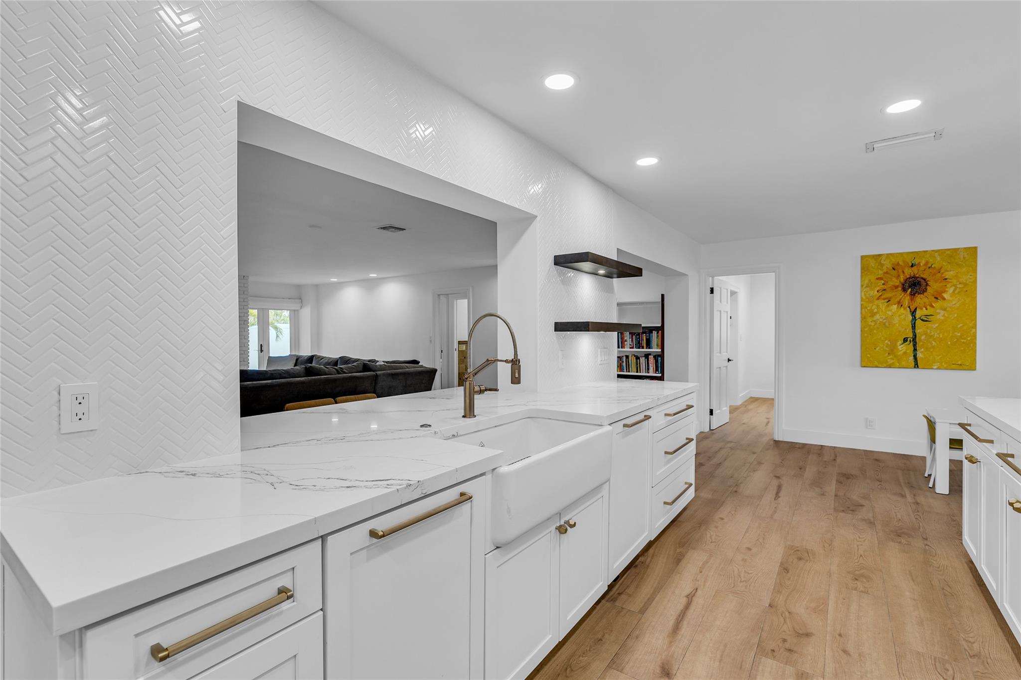 Large open window into back family room with farmhouse sink