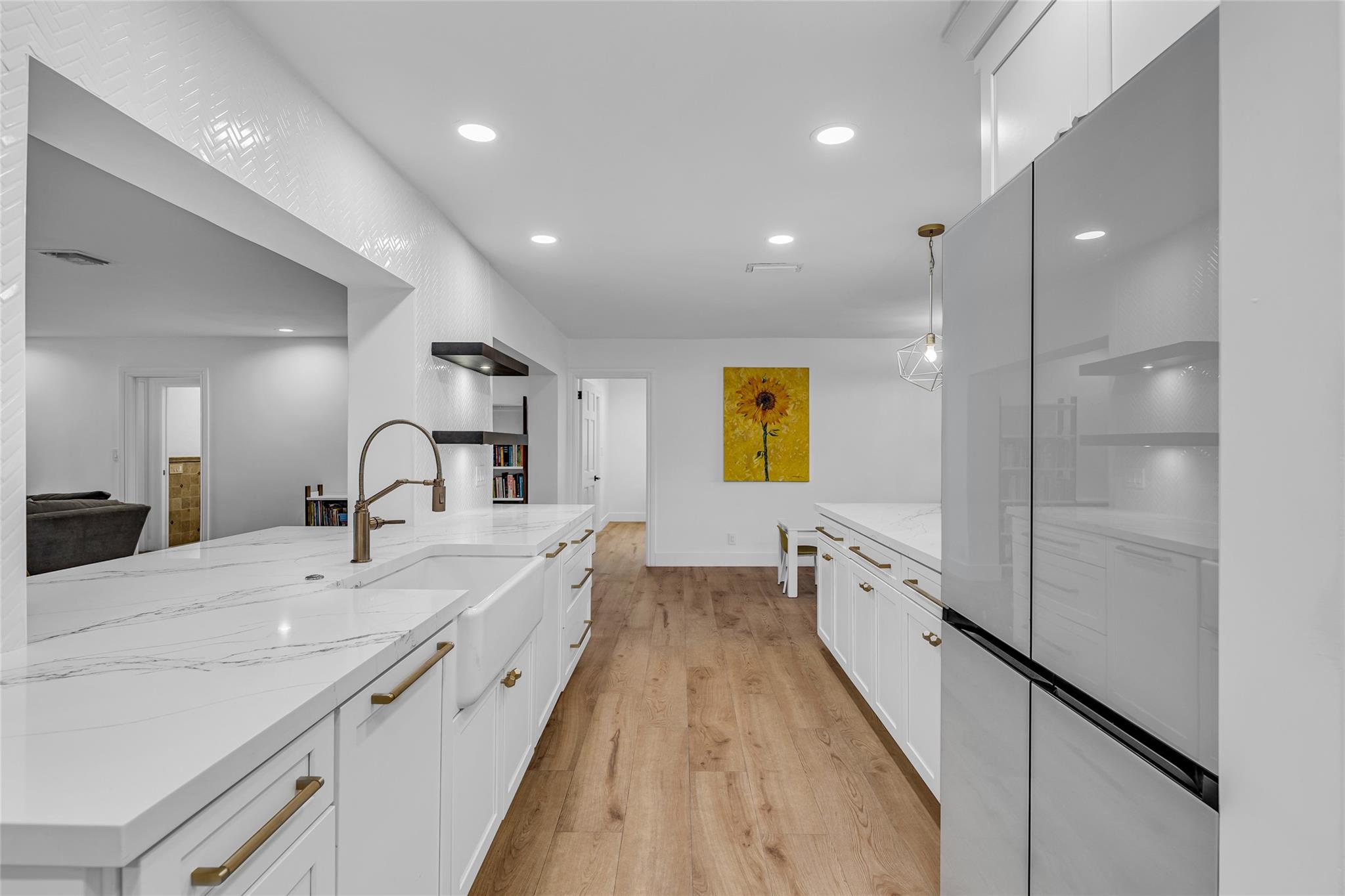 Spacious kitchen with new kitchen aid appliances, quartz counters and farmhouse sink are just a few of the many upgrades