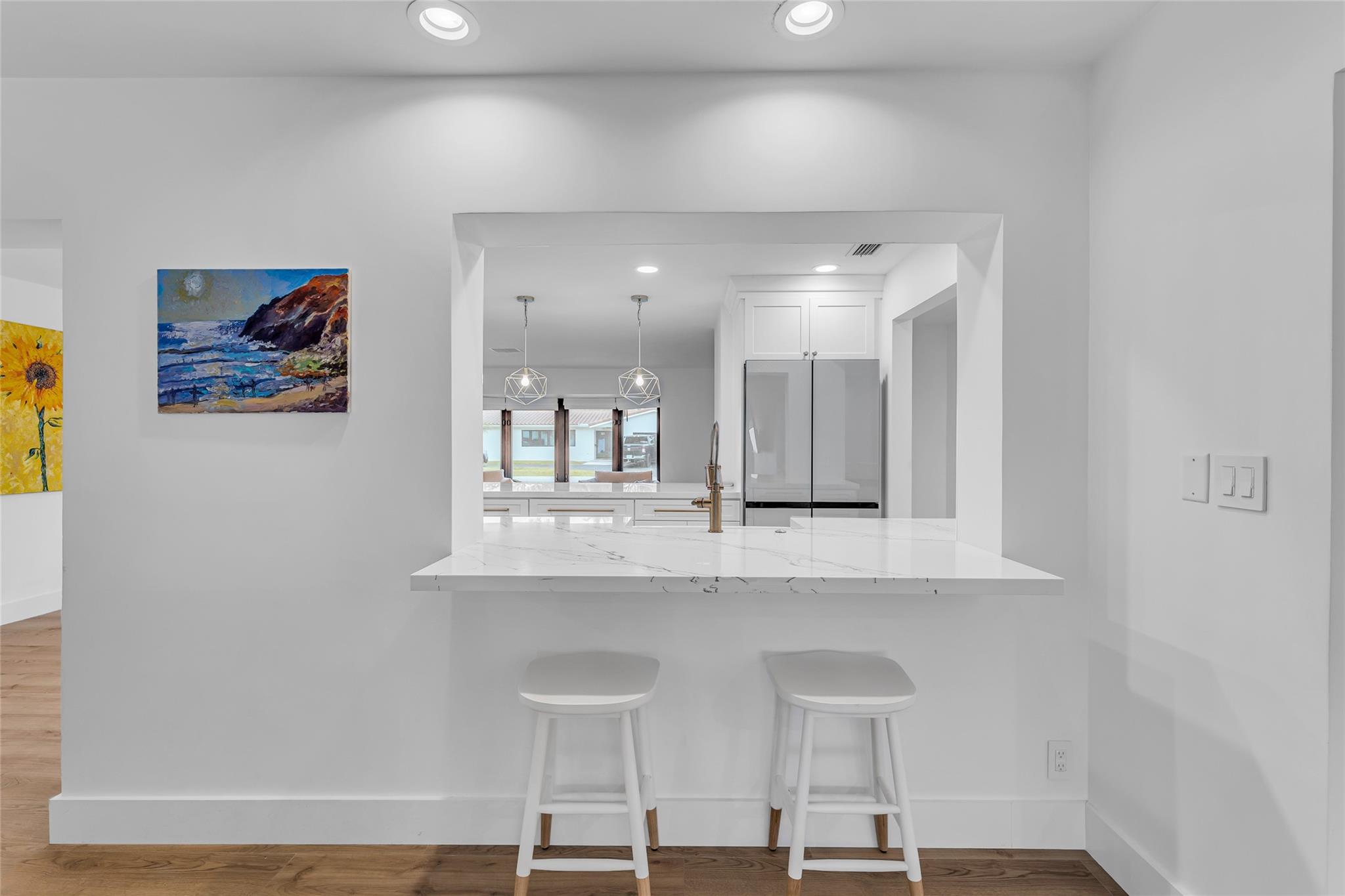 Quartz counter bar shared between kitchen and family room