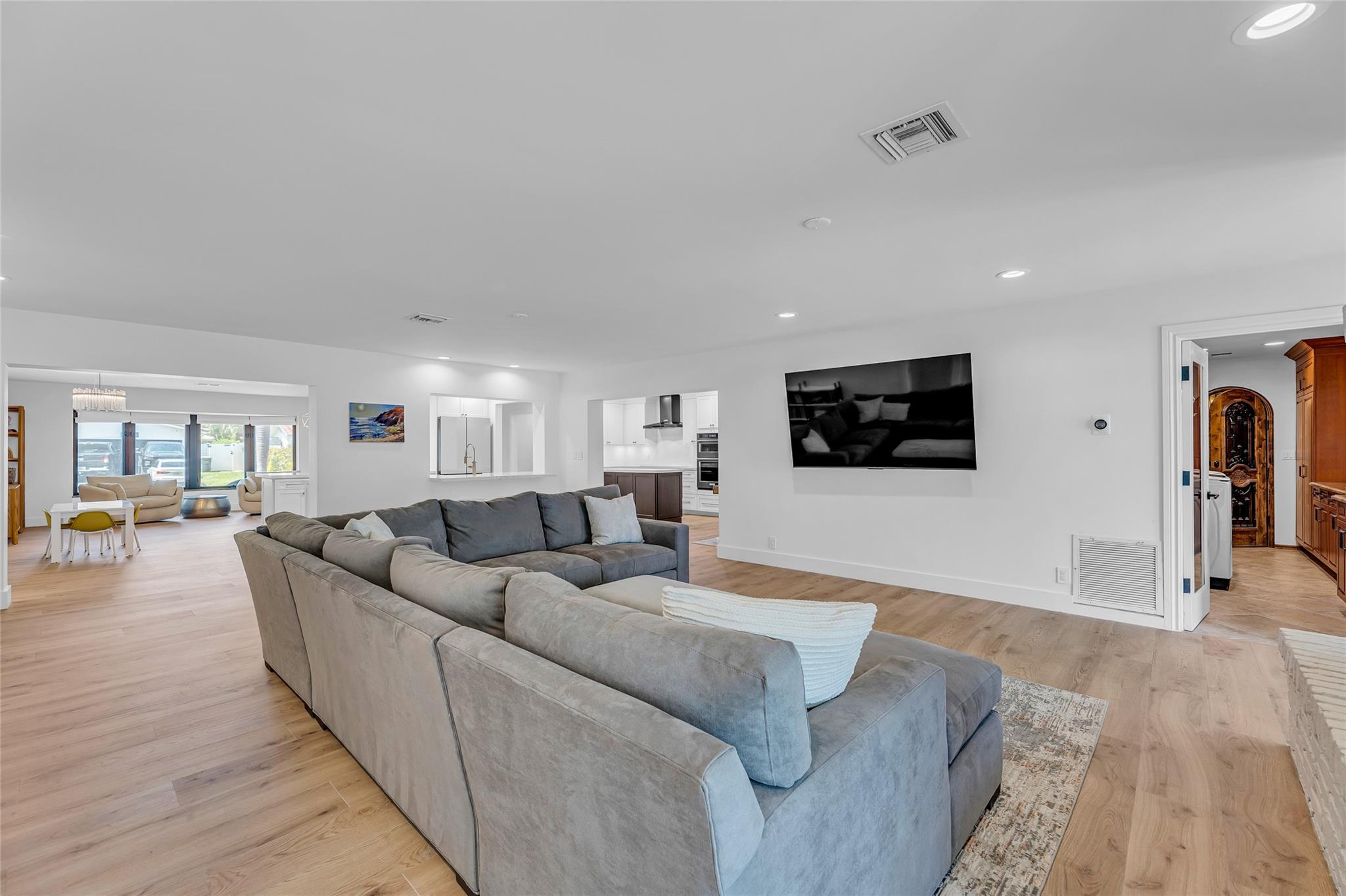 Spacious family room with high-hat lighting and wood plank tile flooring