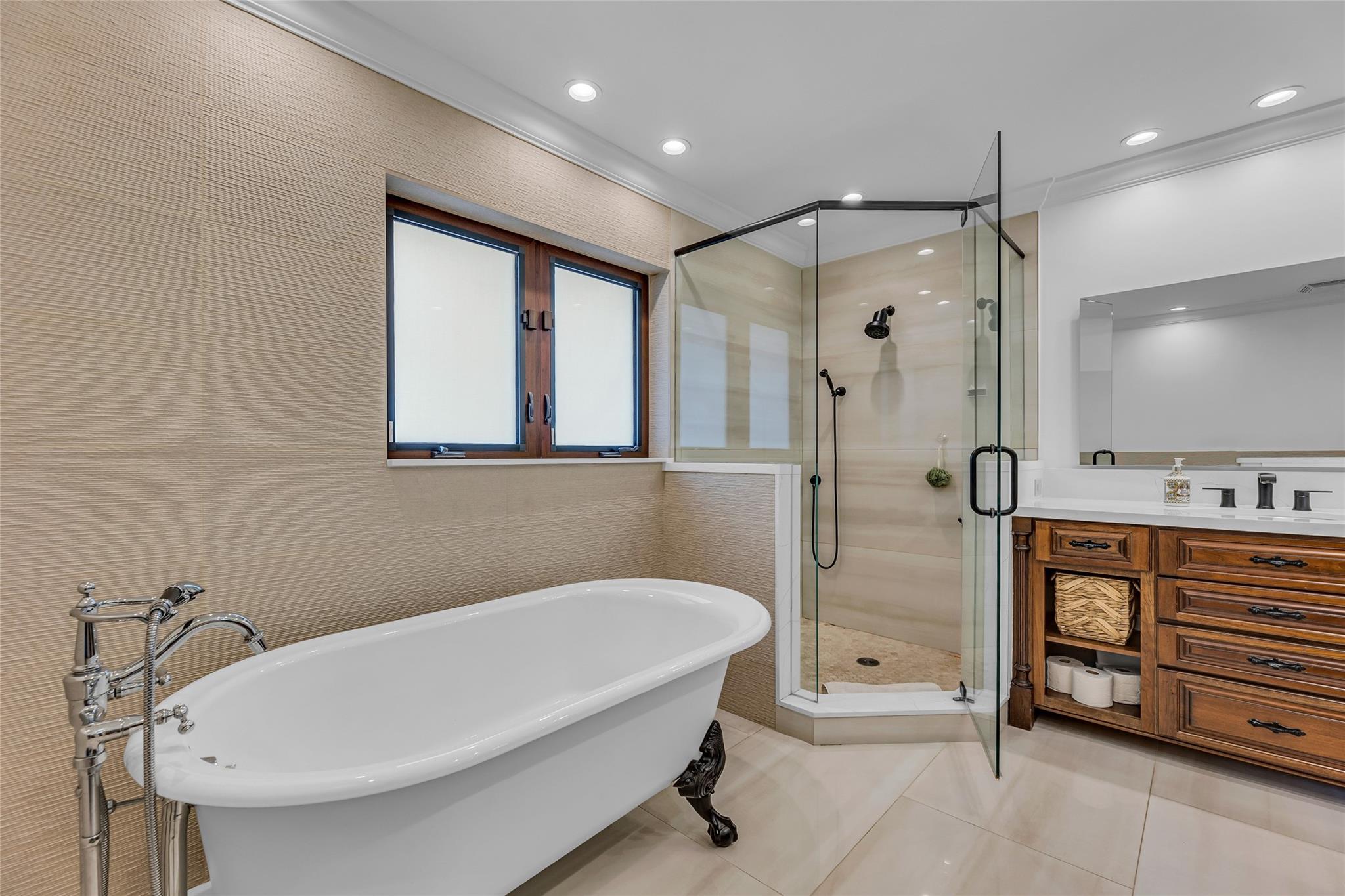 Claw bathtub and walk in shower featured in master bathroom