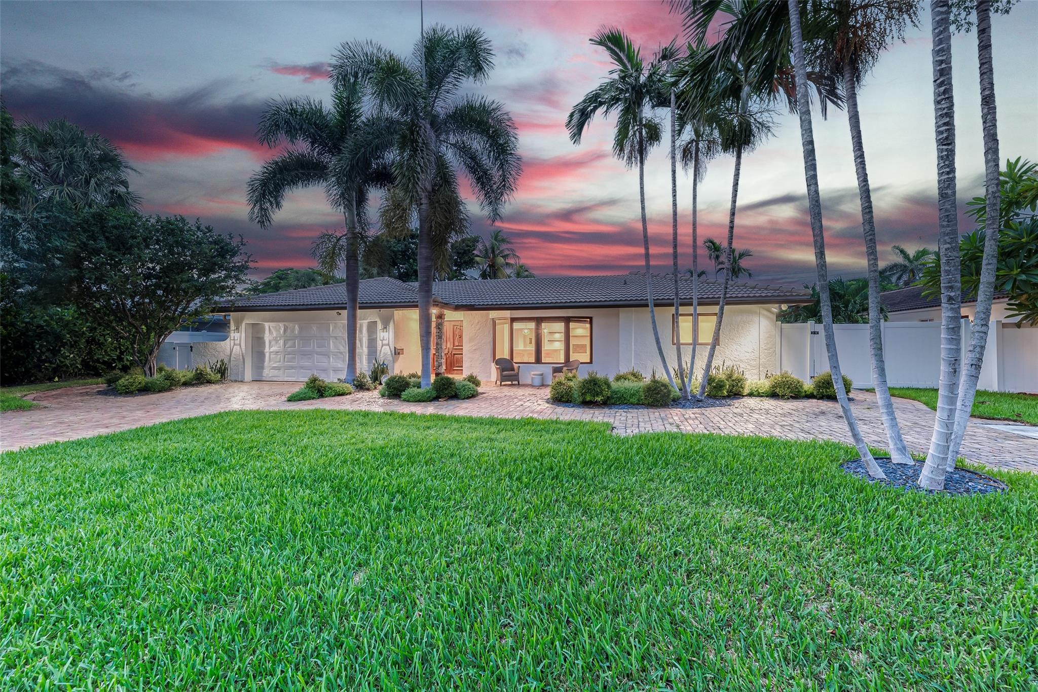 Beautifully landscaped large front yard on this 4 BEdroom / 4 bath home in Lighthouse Point
