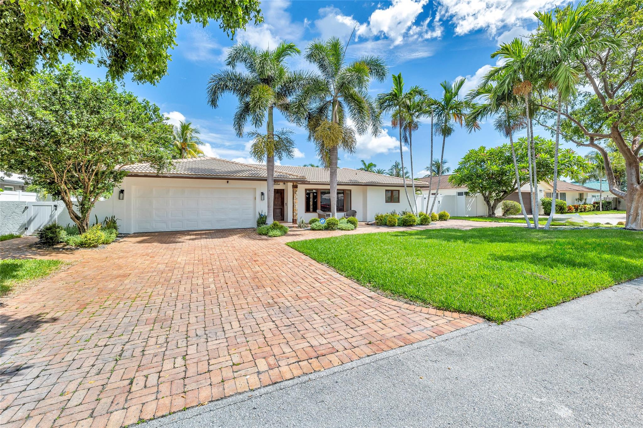 Meticulously landscaped and large front yard and mature trees