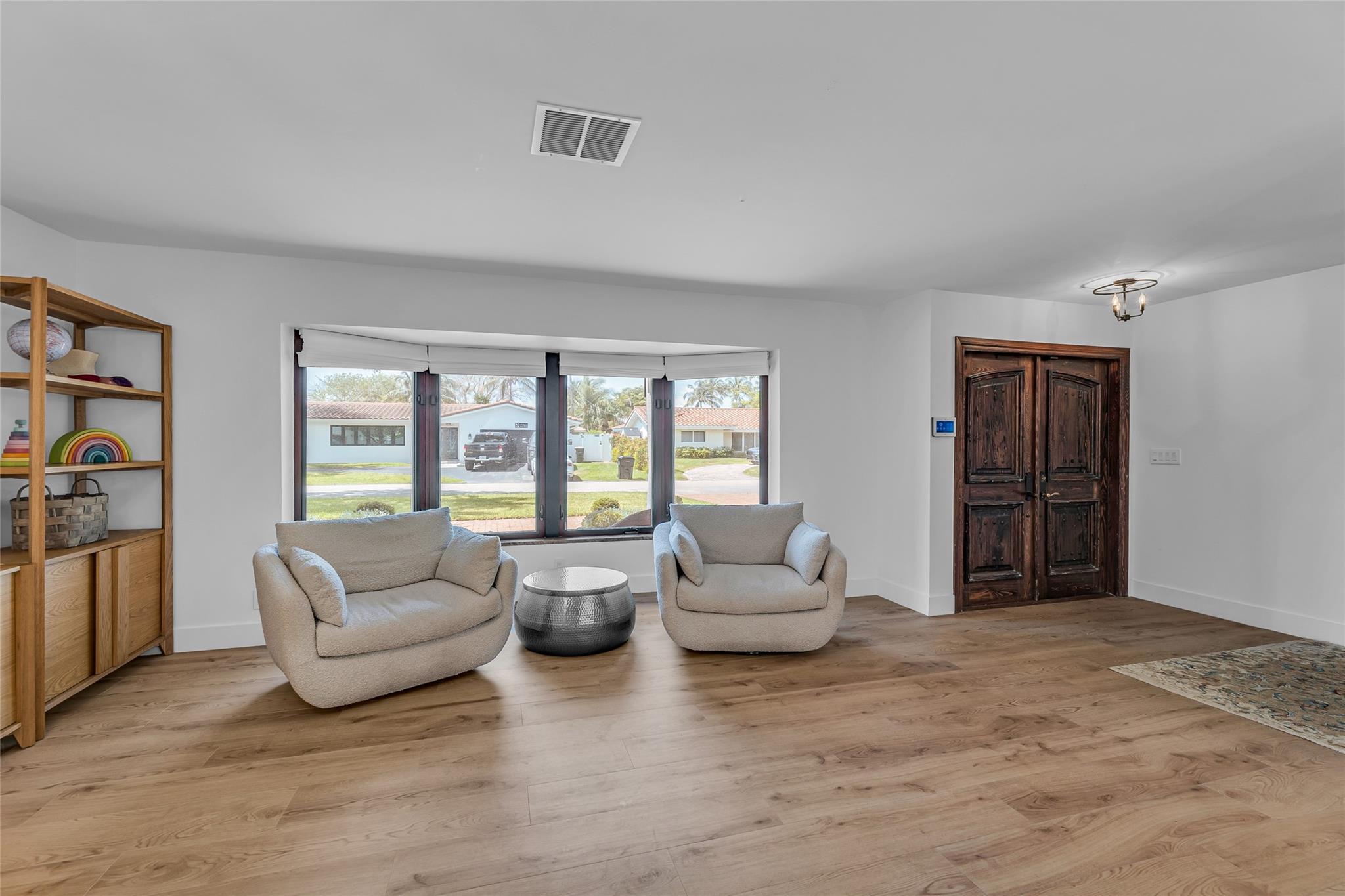 Large and spacious living room with an abundance of natural light from large bay window