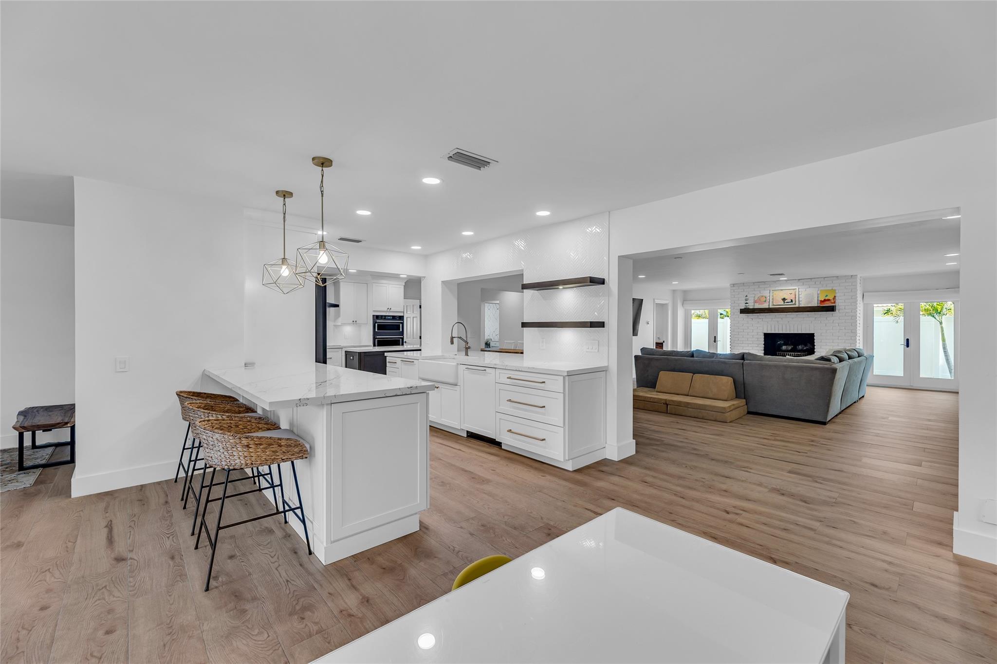 Kitchen is open and spacious and is nestled between the living room and family room and the center of the home