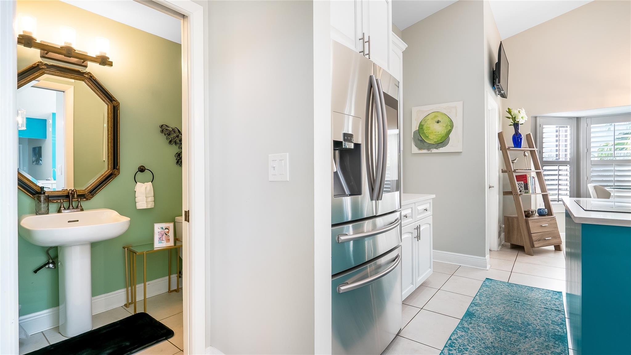 The adjoining half-bath echoes the kitchen's modern aesthetic, providing convenience and luxury with top-tier fixtures and finishes.