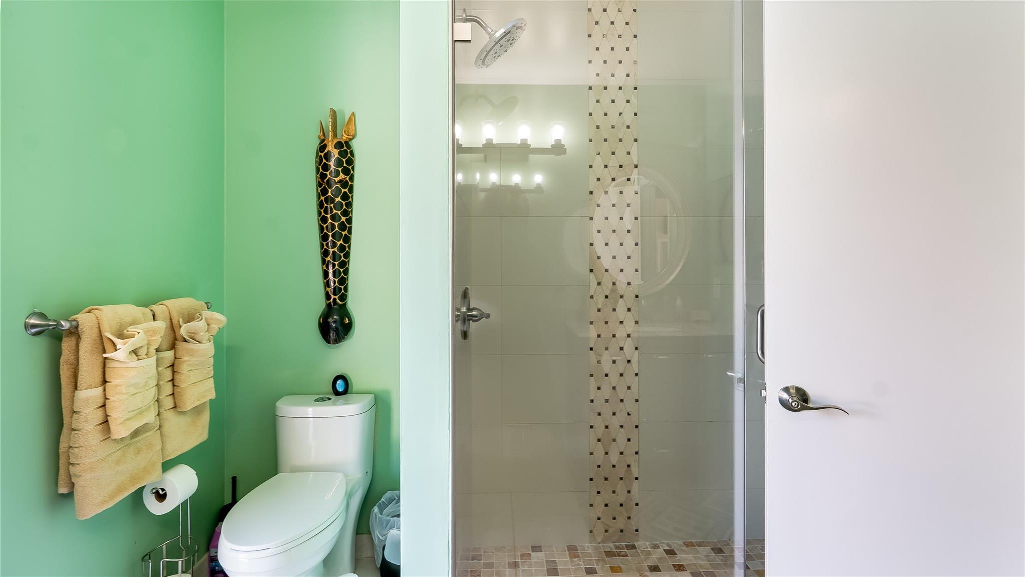 Notice the beauty of the seamless glass shower.