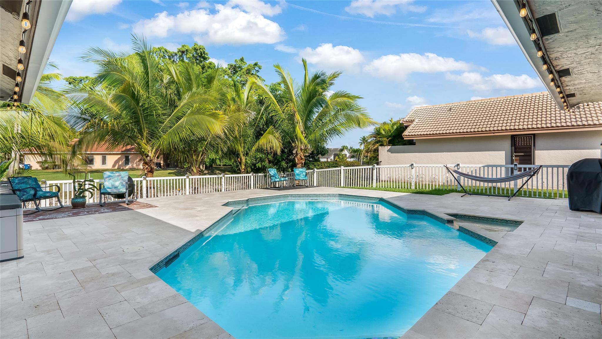 View of pool/spa and backyard from Cabana Bathroom Door