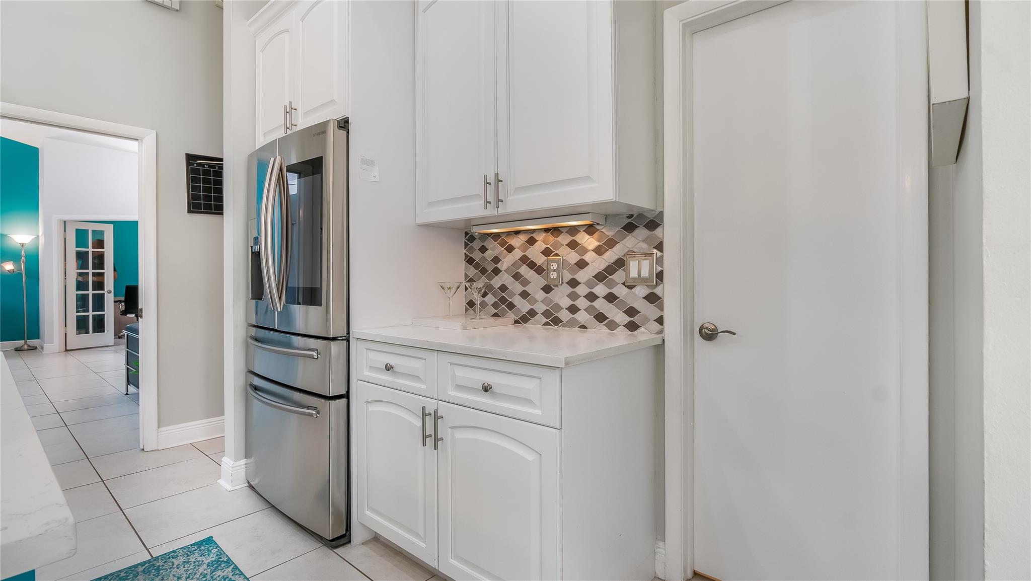 be captivated by the seamless transition from the gourmet kitchen to the expansive open-concept living area.