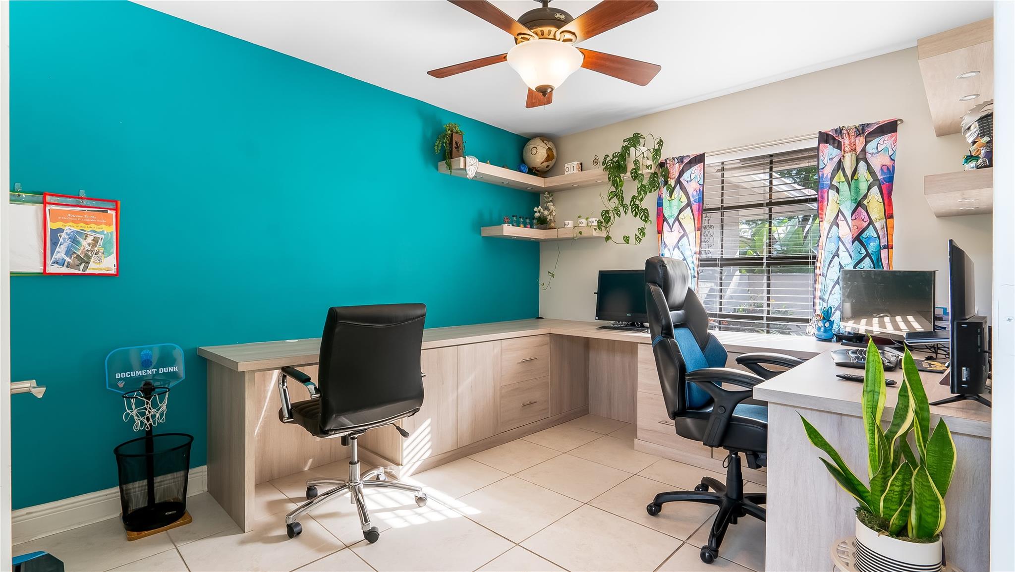 An air of elegance and warmth is achieved through the exquisite wood finishes and quality architecture. Every book, file, and office supply has its thoughtfully designed place, minimizing clutter. The spacious layout allows flexibility to integrate multiple workstations or collaboration spaces.