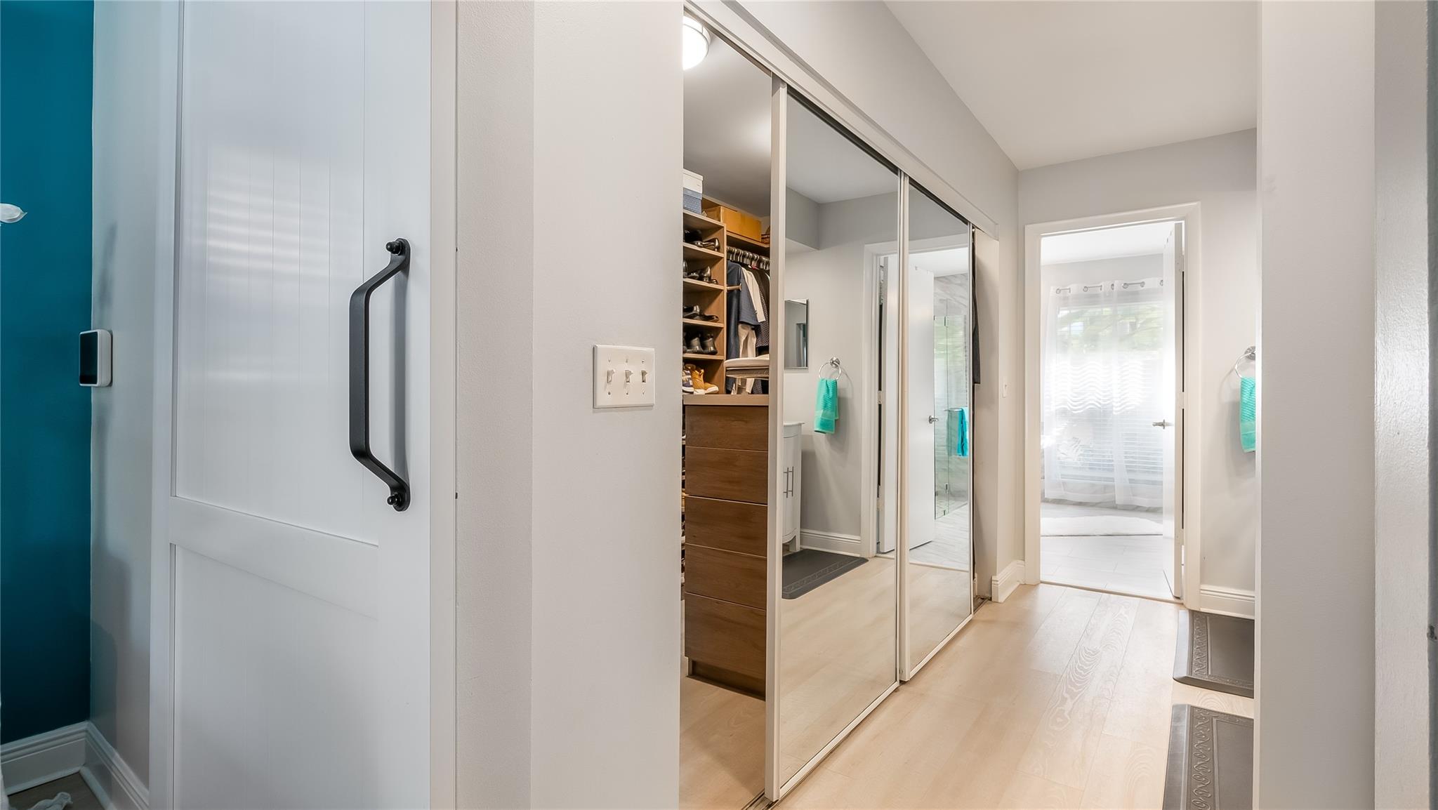 Just steps away, the exceptional custom-fitted walk-in closet showcases built-in shelving, drawers, and hanging rods to accommodate even the most extensive wardrobe and accessories