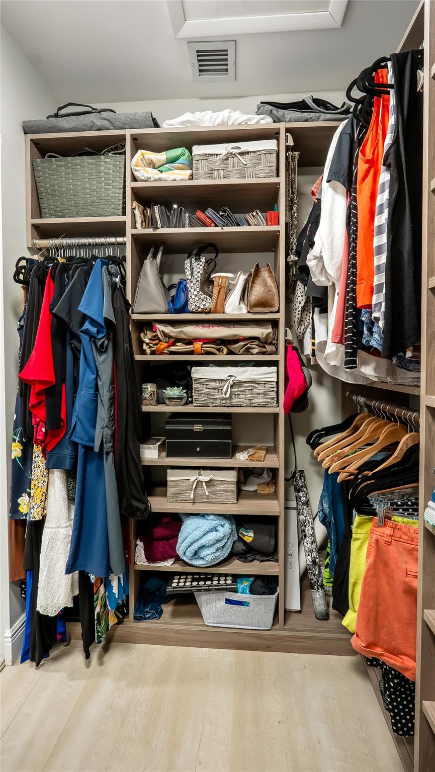 
Exceptional custom-fitted walk-in closet showcases built-in shelving, drawers, and hanging rods to accommodate even the most extensive wardrobe and accessories