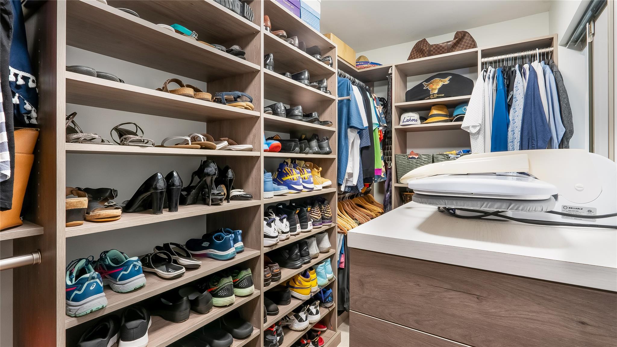 fitted walk-in closet showcases built-in shelving, drawers, and hanging rods to accommodate even the most extensive wardrobe and accessories