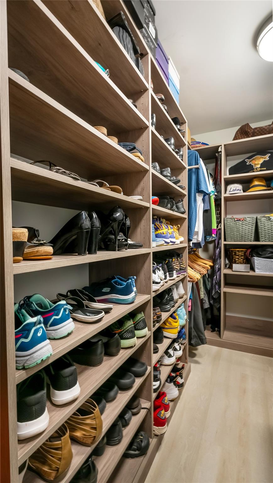 fitted walk-in closet showcases built-in shelving, drawers, and hanging rods to accommodate even the most extensive wardrobe and accessories