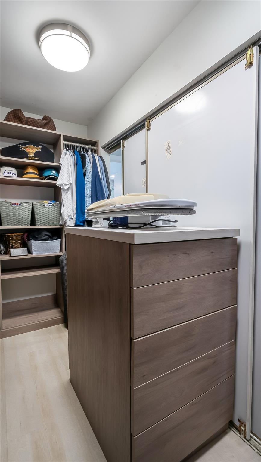 fitted walk-in closet showcases built-in shelving, drawers, and hanging rods to accommodate even the most extensive wardrobe and accessories