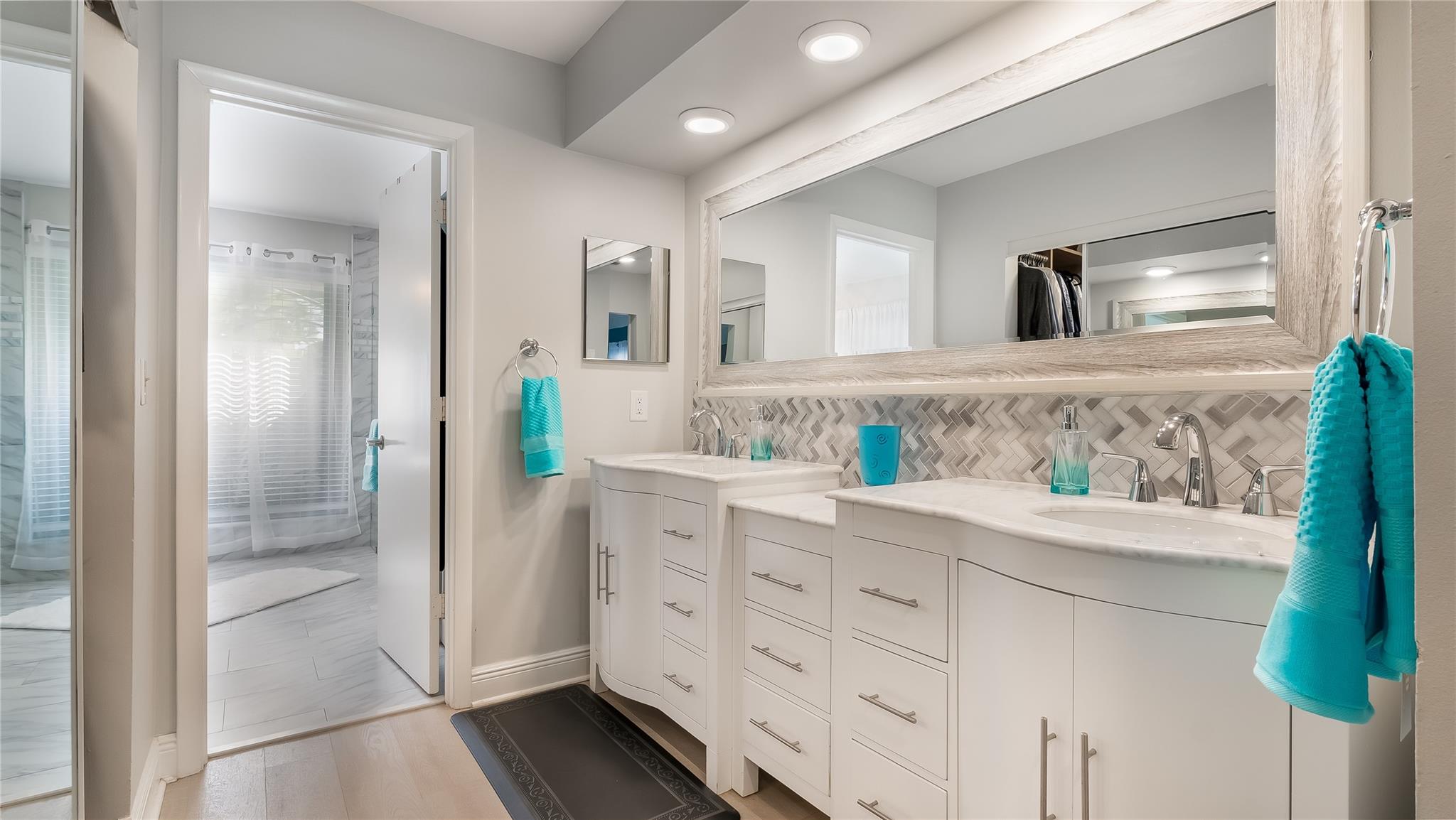Dual vanities offer ample countertop space and storage.