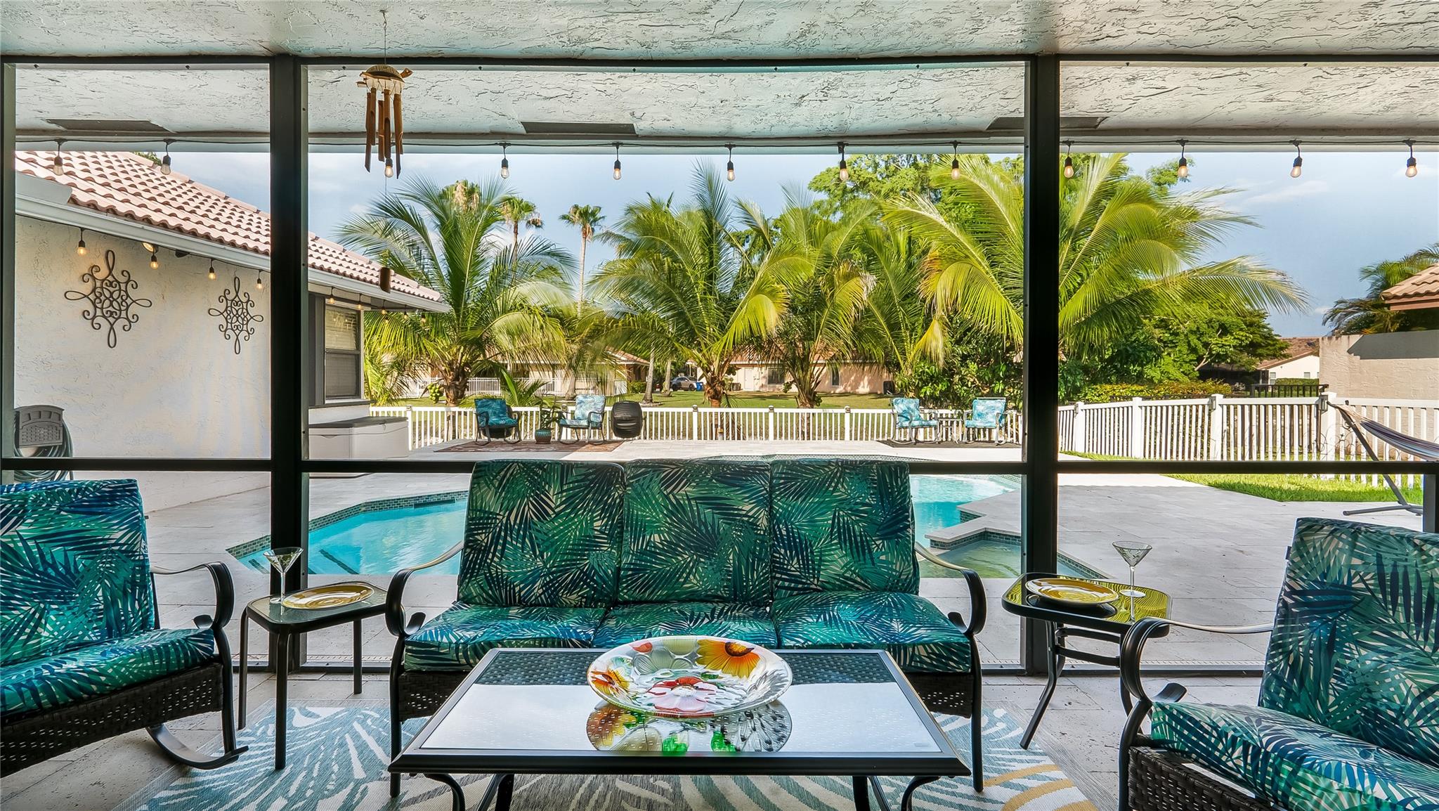 The covered patio truly recaptures the essence of cherished Florida living - embracing indoor/outdoor harmony against a private, scenic backdrop.
