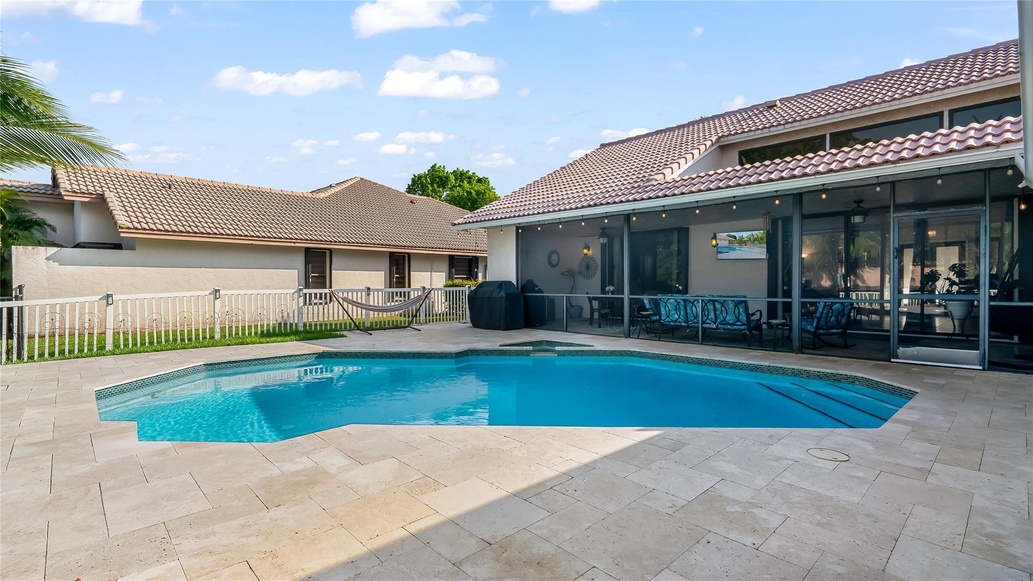 Whether hosting an elegant soiree, enjoying casual meals alfresco, or simply relaxing book-in-hand, this resort-like outdoor living room provides the ultimate setting.