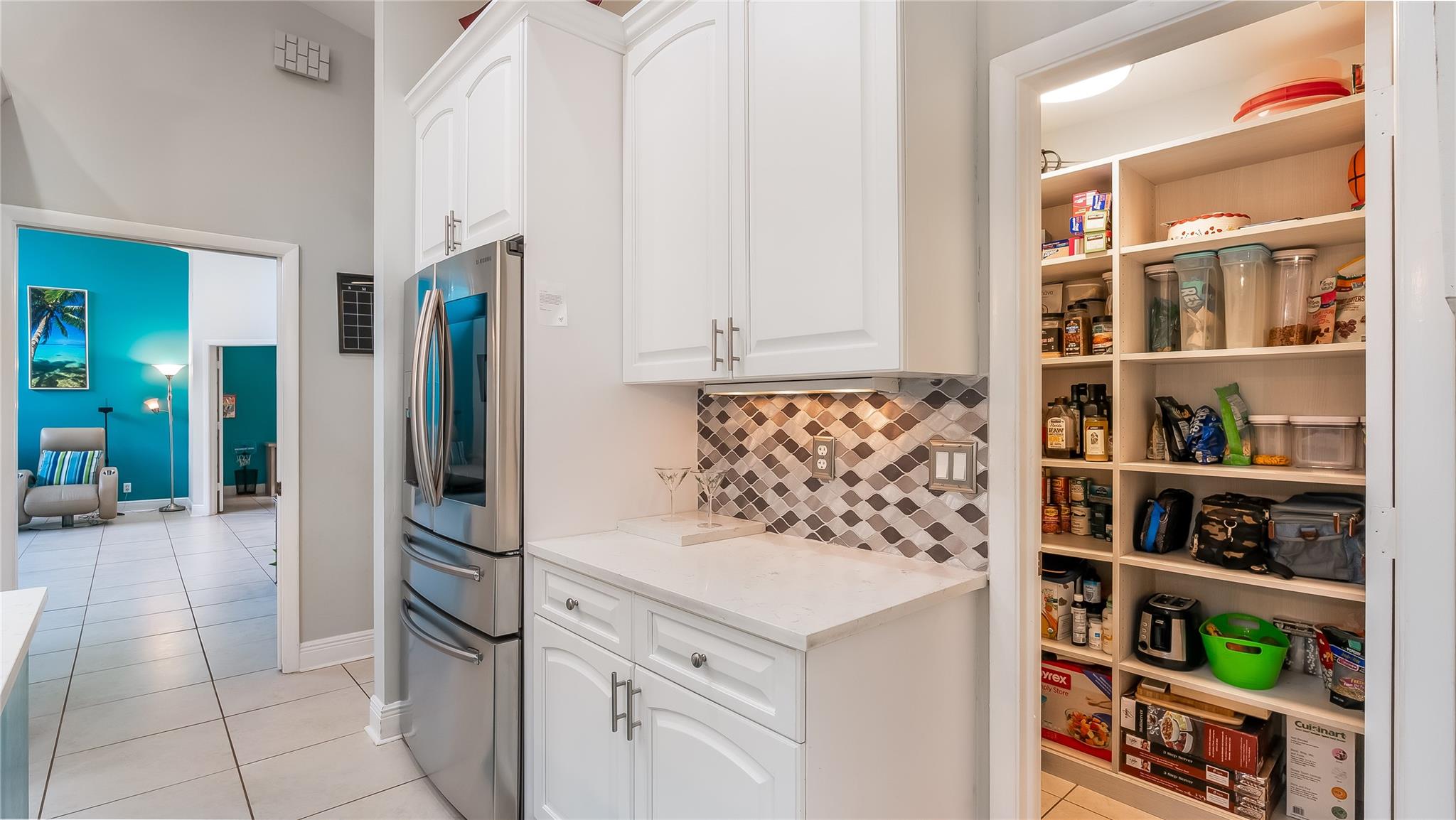 The pantry boasts custom shelving designed to maximize space and accessibility, ensuring all your culinary essentials are within reach.