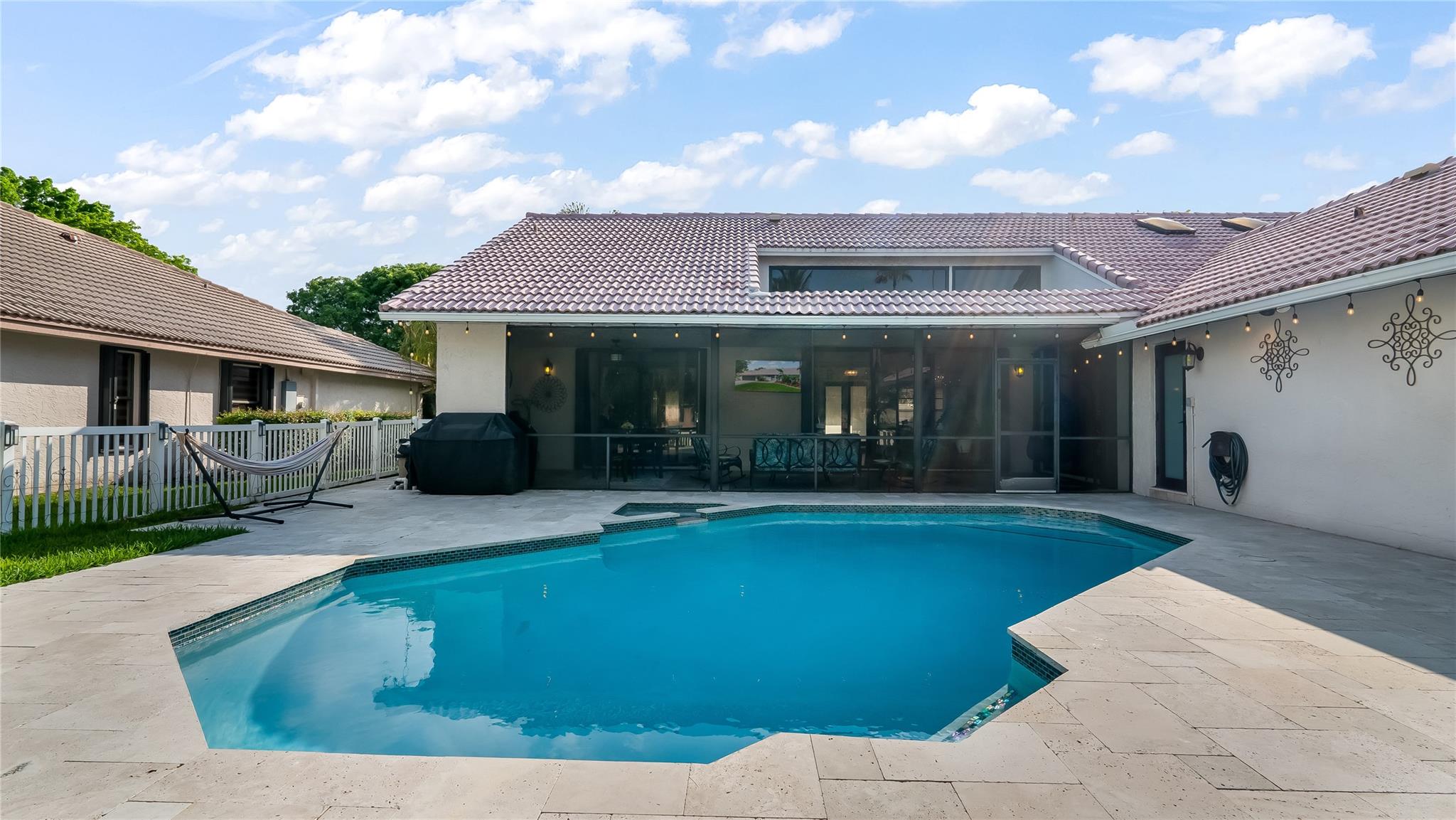 Ample deck space surrounds the pool, offering plenty of room for lounging and alfresco dining.