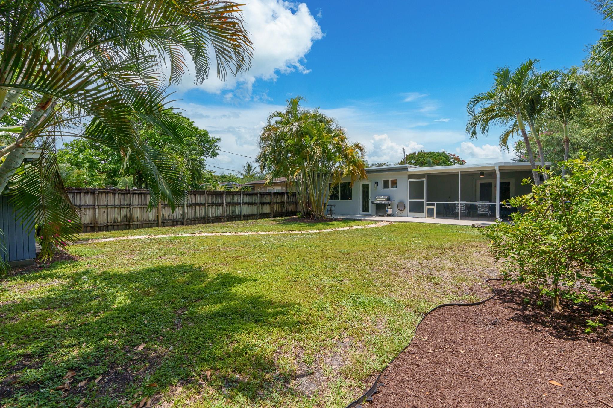 A view toward the back of the home from the corner of the back yard
