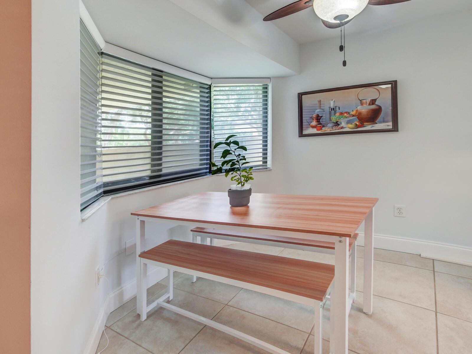 New window treatments and bay style window in the eat-in-kitchen