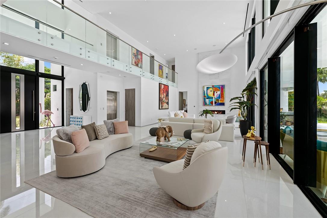 GRAND LIVING ROOM WITH SOARING CEILING AND NATURAL LIGHT